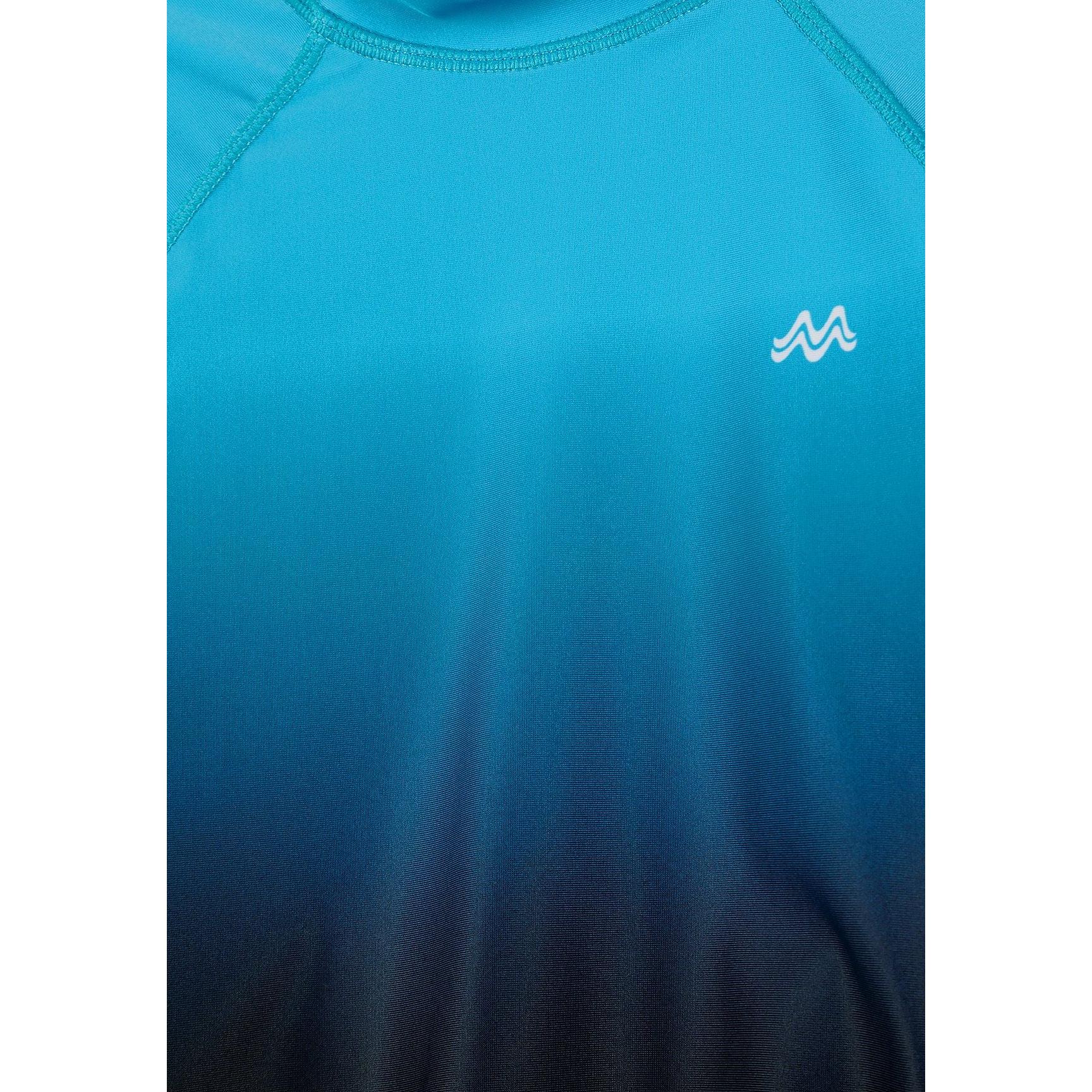 Close-up detail of blue ombre gradient fabric with white Minoti logo showing colour fade from turquoise to navy