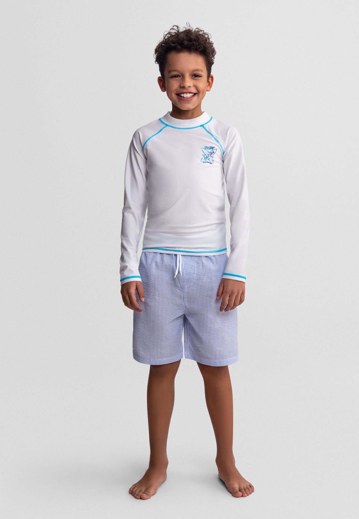 Blue/white and green/white swim shorts, model wearing blue stripe.
