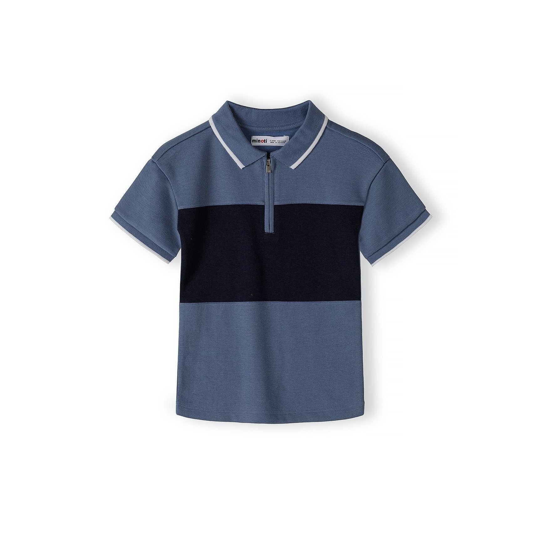 Close-up detail of navy blue pique polo shirt showing Minoti label, zip fastening and colour-block design with textured fabric