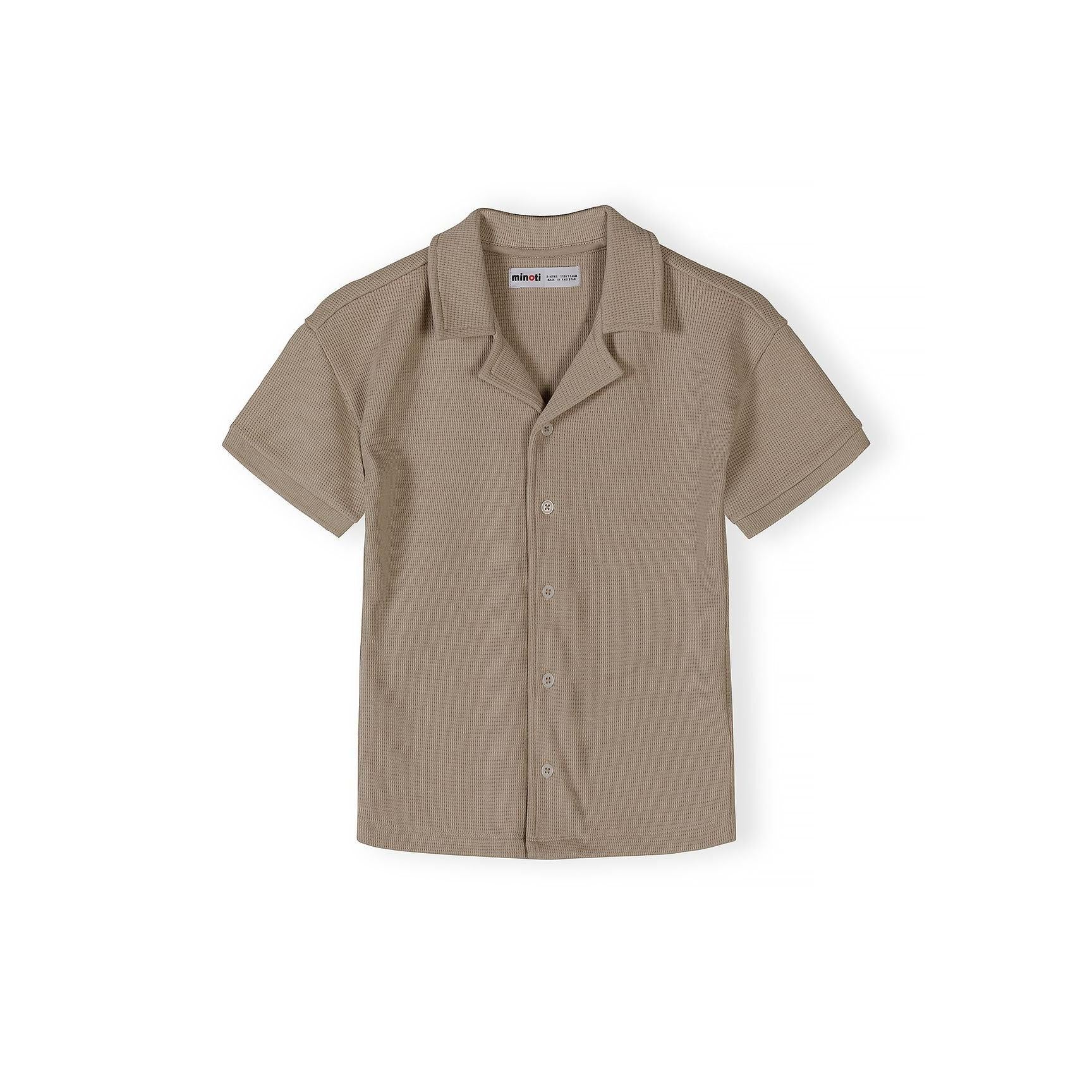 Close-up detail of taupe waffle cotton shirt showing Minoti label, button placket and textured fabric weave