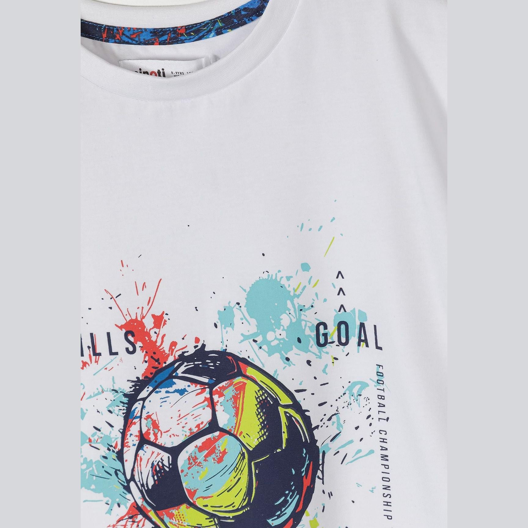 Close-up detail of blue football print t-shirt showing Minoti label and colorful soccer balls with paint splatter effect in blues, greens, reds and yellows