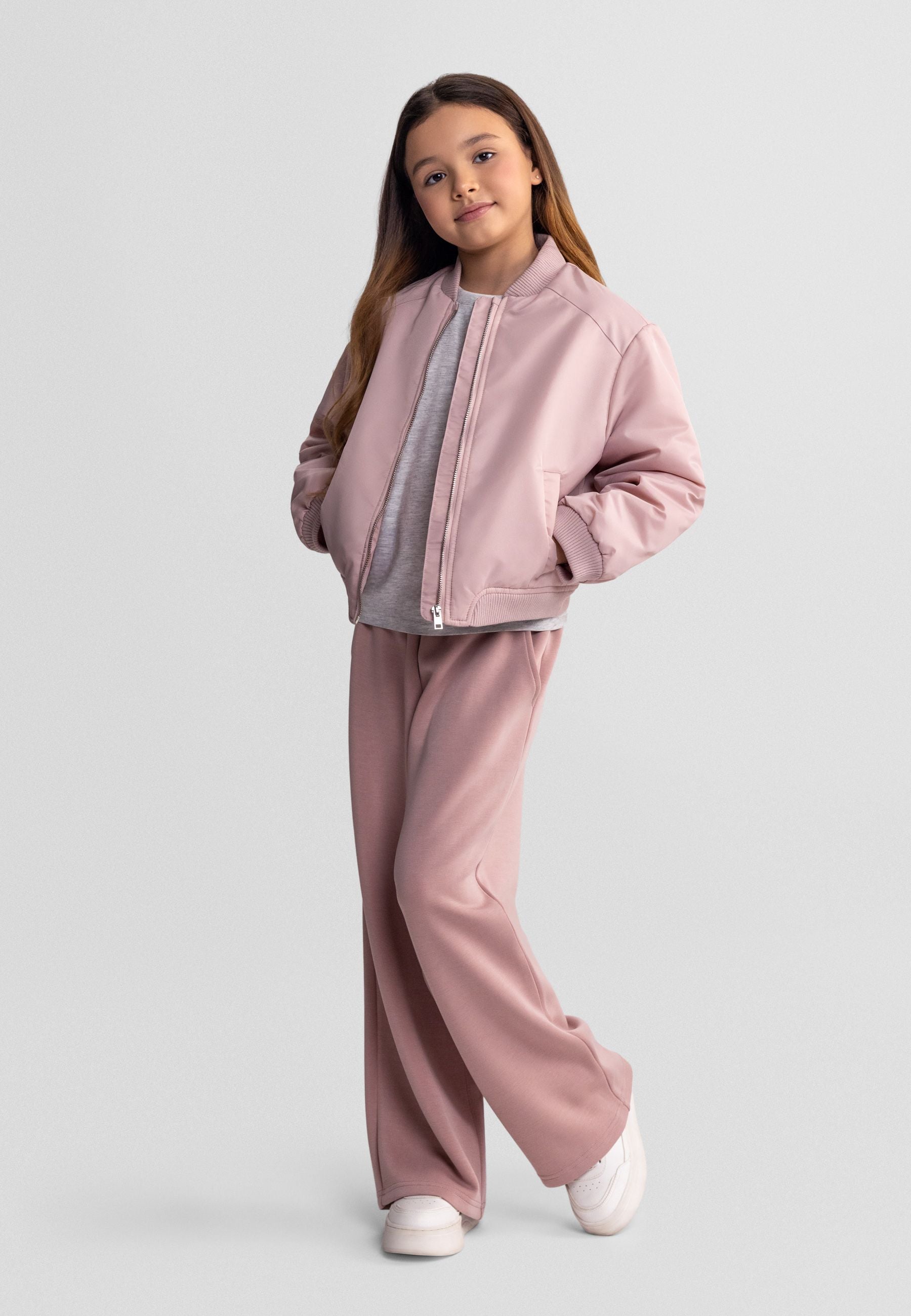 Girls lightweight pink bomber jacket, front view, features ribbed collar and zip closure.