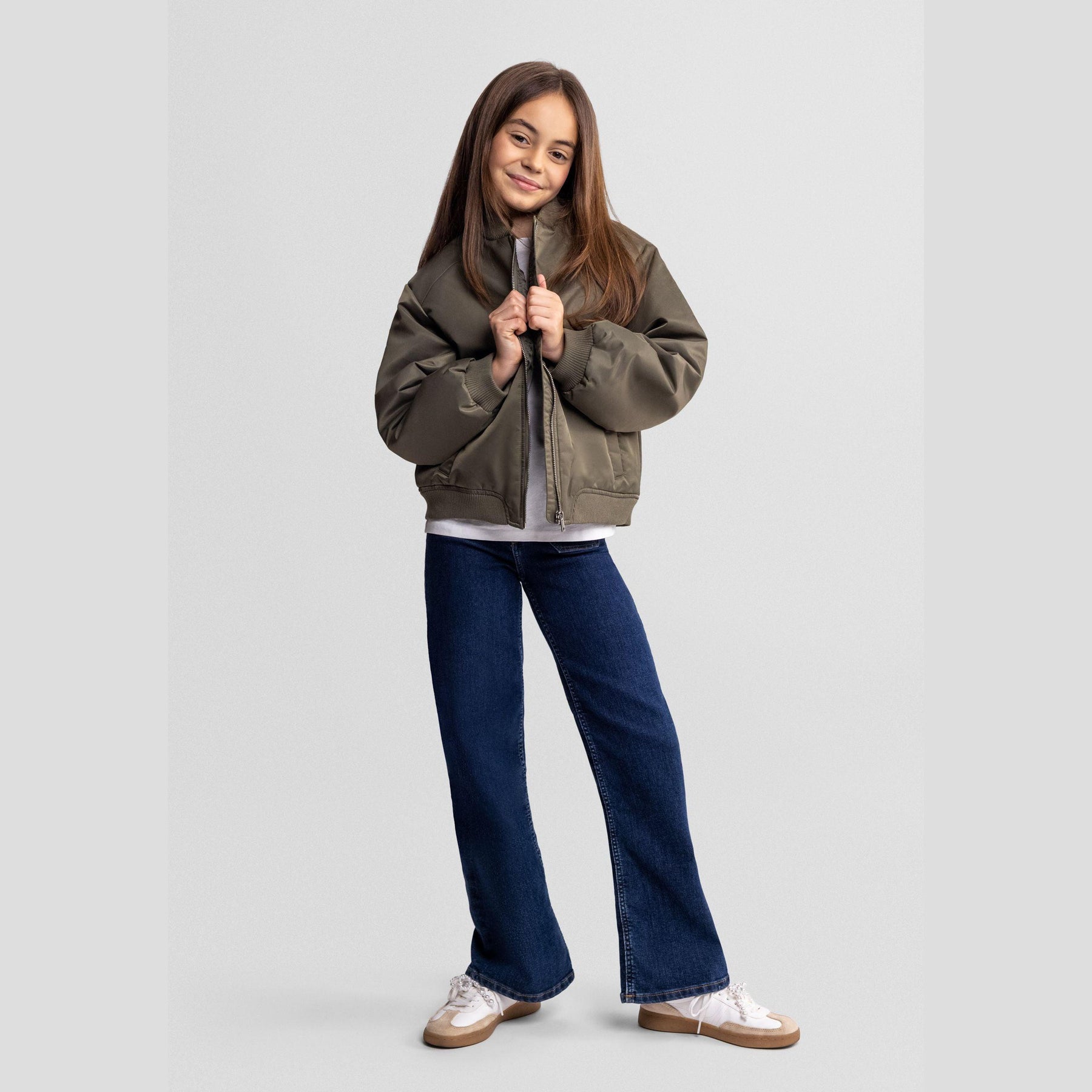 Flat lay of khaki bomber jacket showing ribbed collar, zip front closure and overall construction on white background