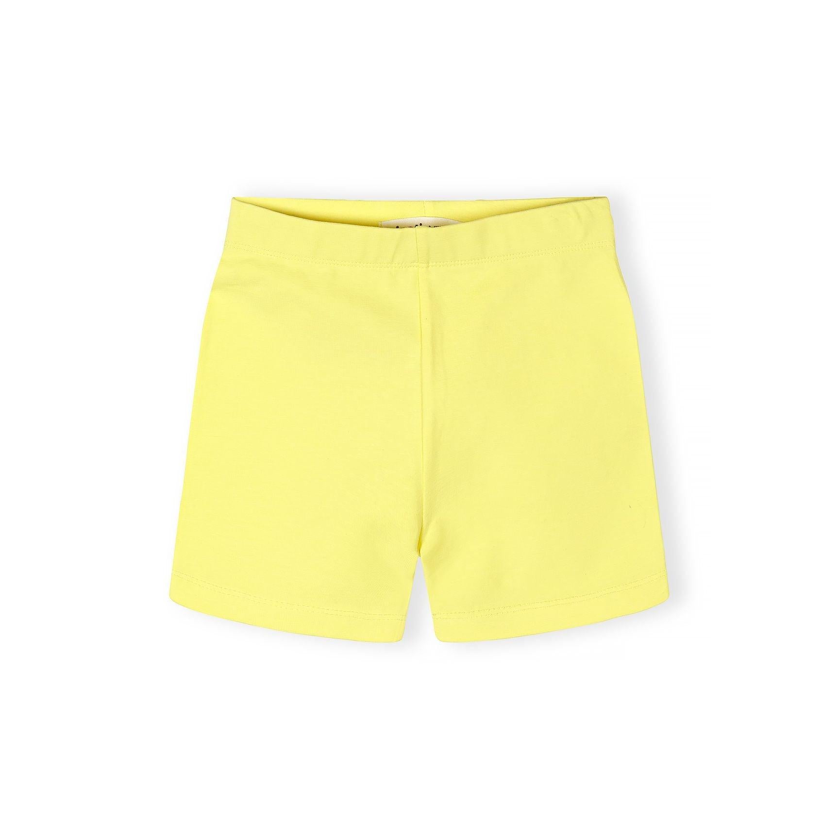 Close-up detail of coral pink cycle shorts showing Minoti brand label inside waistband and soft cotton stretch fabric texture