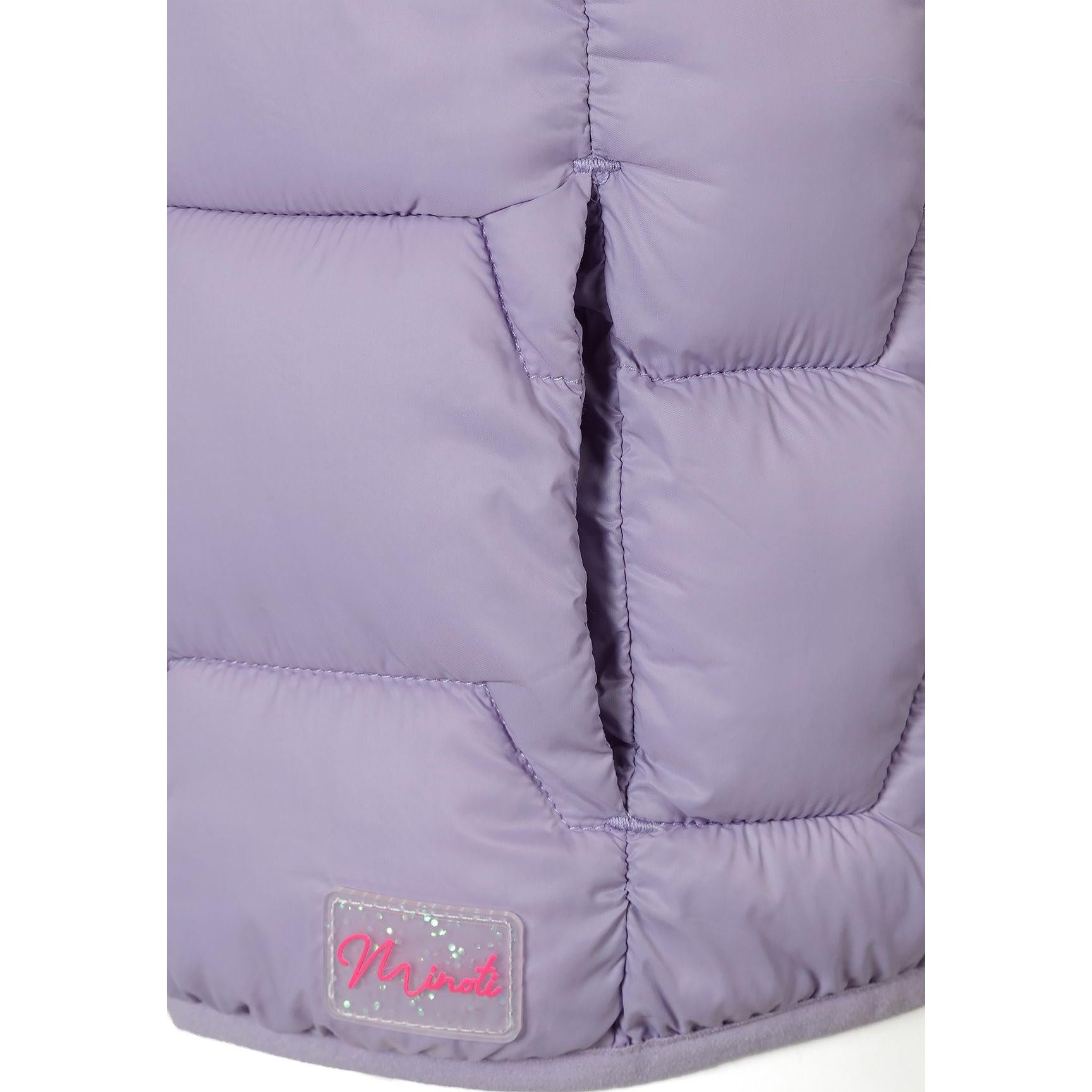 Close-up detail of lilac gilet showing quilted padding pattern and pink Minoti logo patch on hem