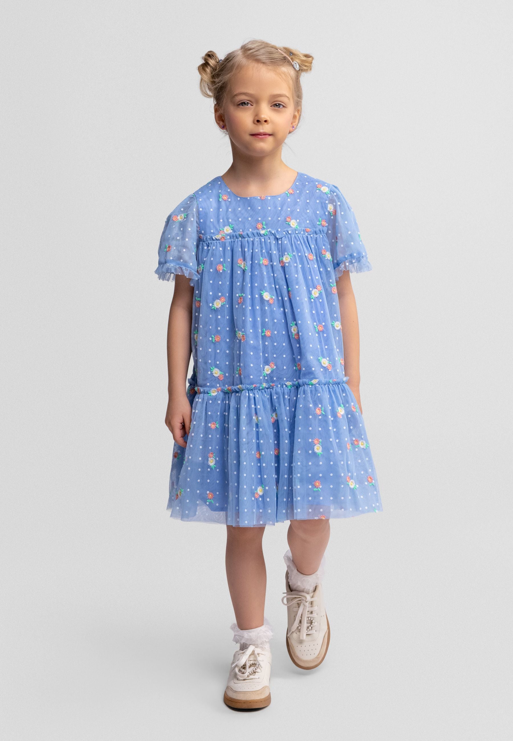 Girls blue embroidered tulle dress with tiered skirt and short sleeves, front view.