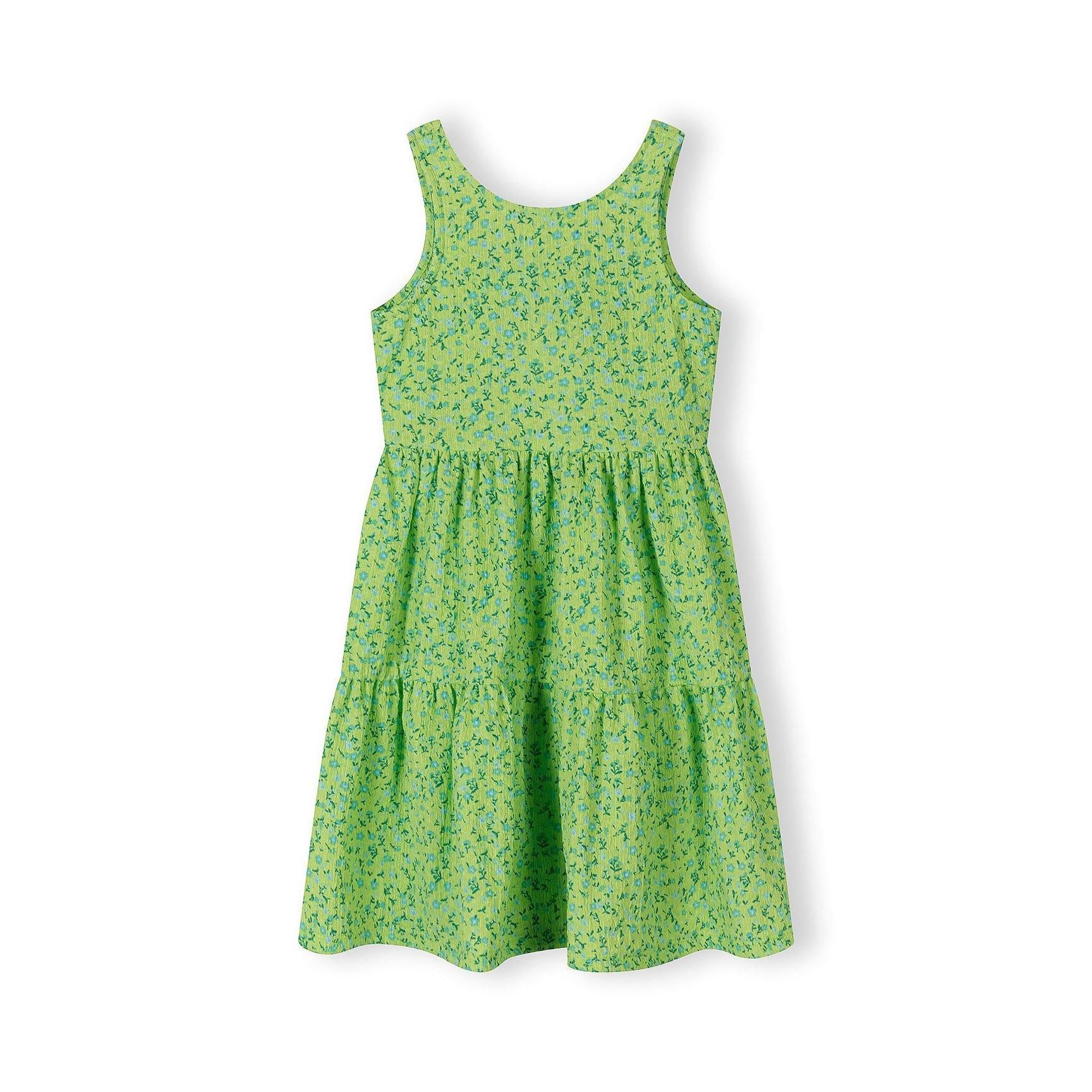 Emerald green floral dress laid flat showing sleeveless design with tiered skirt and tie-back detail, white background