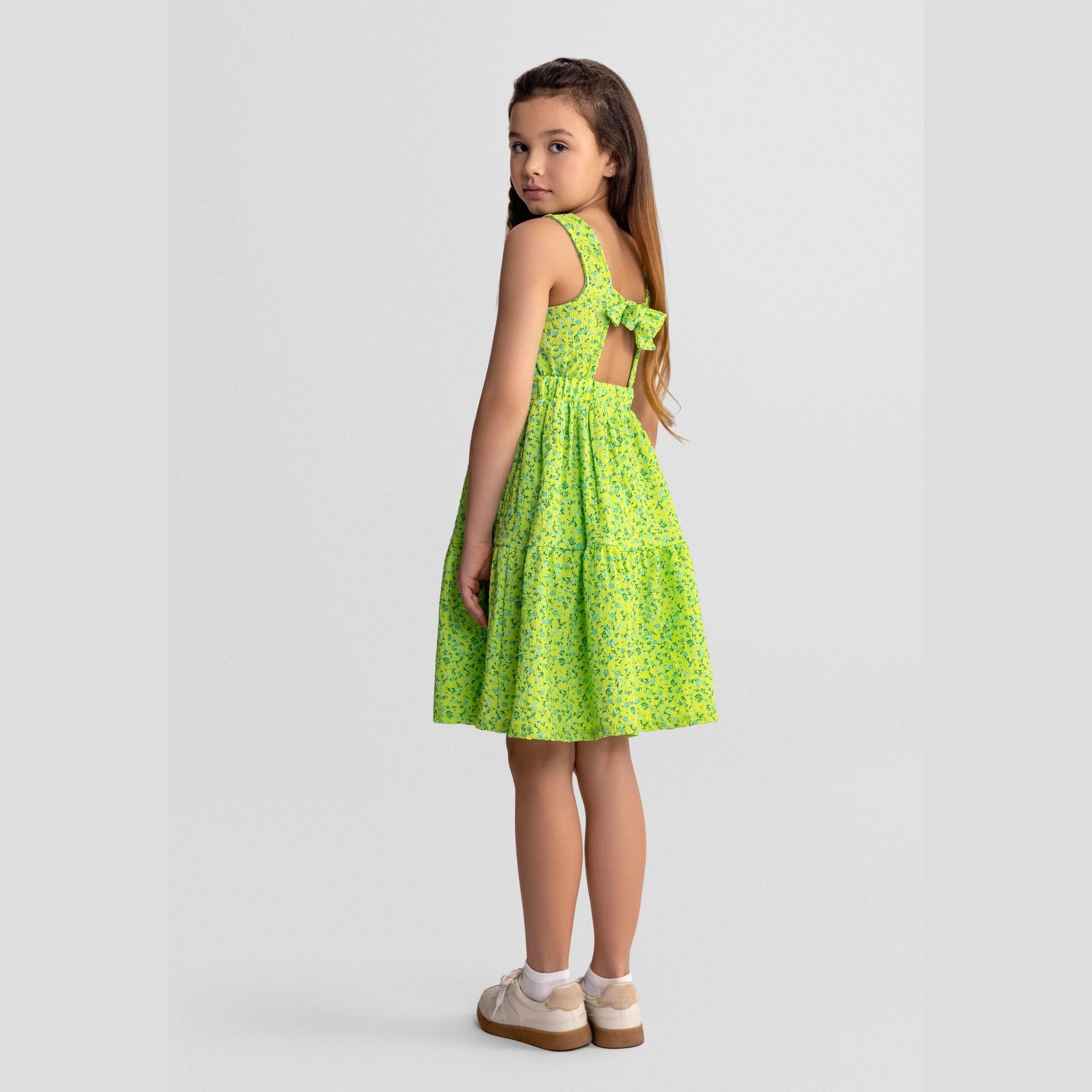 Emerald green floral dress laid flat showing sleeveless design with tiered skirt and tie-back detail, white background