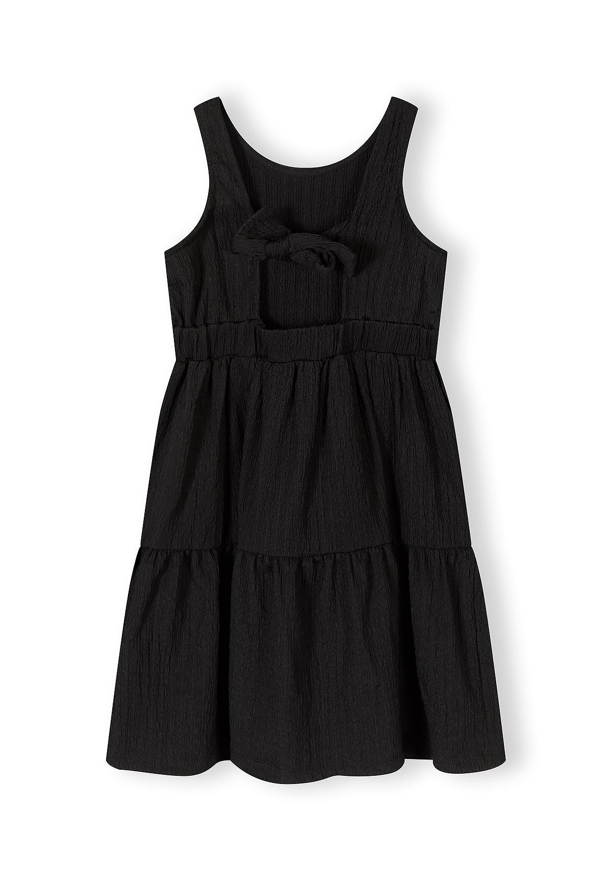 Girls tiered sleeveless black summer dress, front view with bow detail.