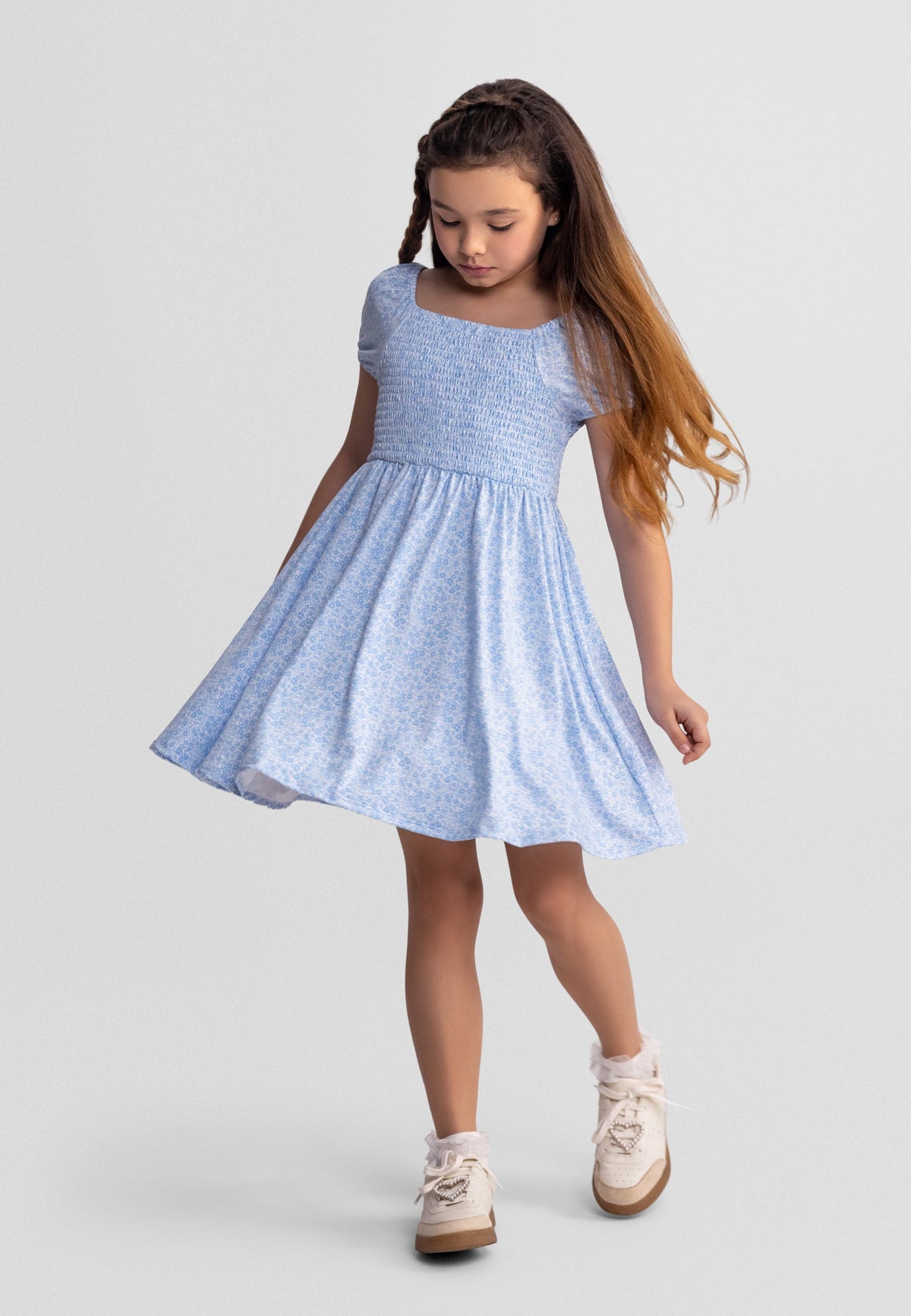 Light blue and white shirred floral dress, model front.