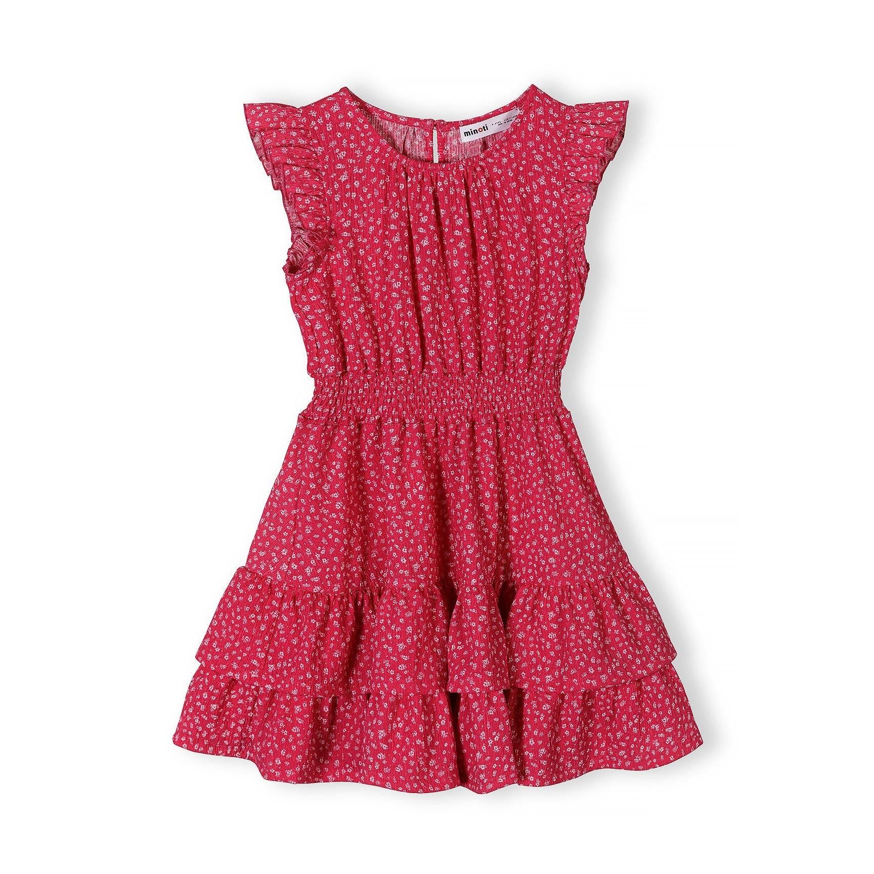 Pink floral dress laid flat showing frill sleeves, elasticated waist, tiered skirt design and white floral print pattern on pink fabric