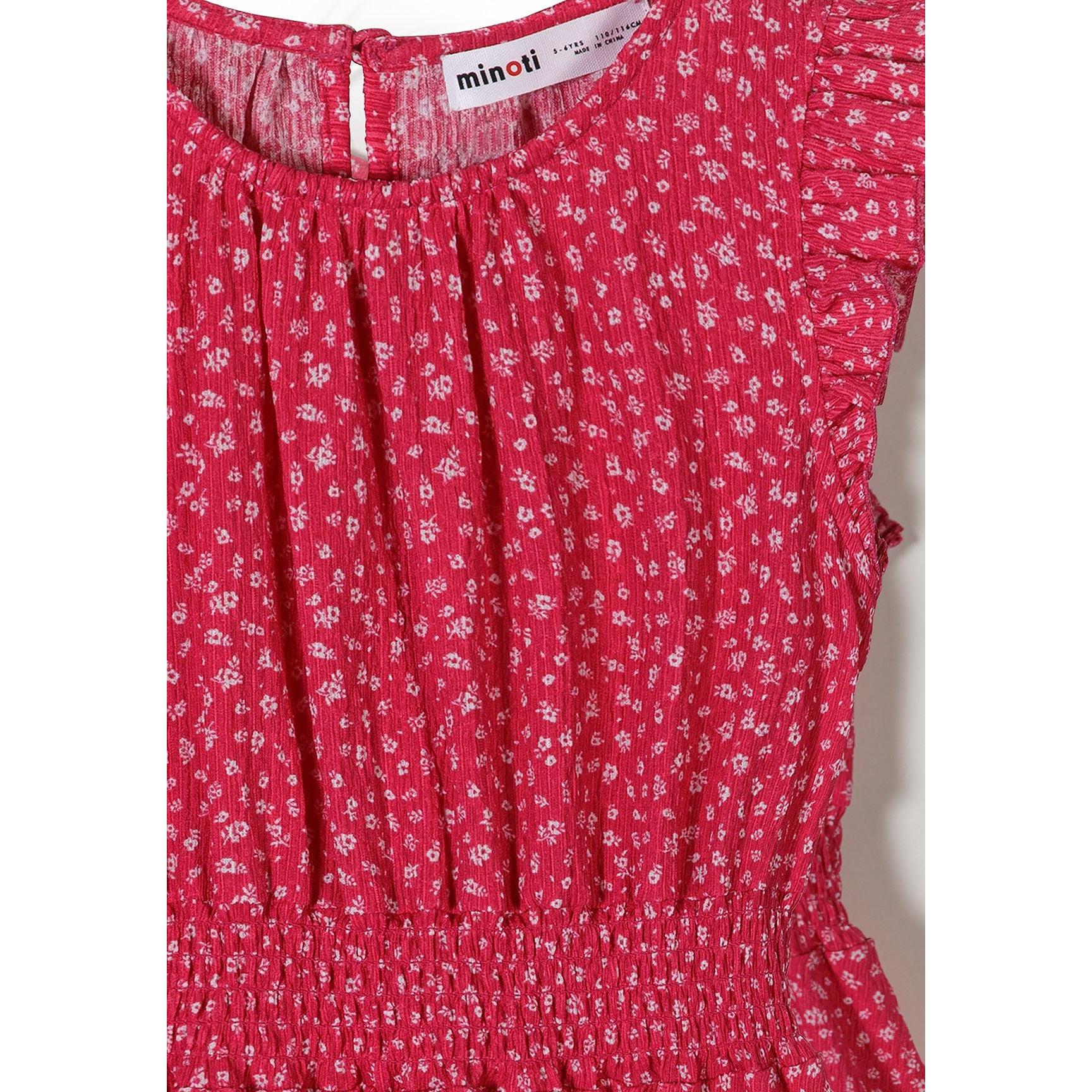Close-up detail of pink dress showing Minoti label, elasticated waist construction, white floral print pattern and fabric texture