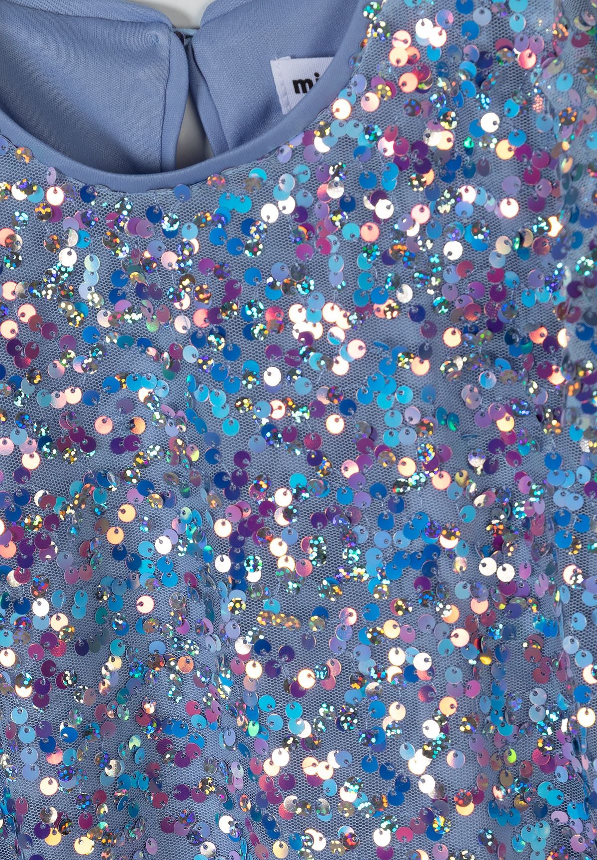 Close-up of blue dress neckline and multicolour iridescent sequins.