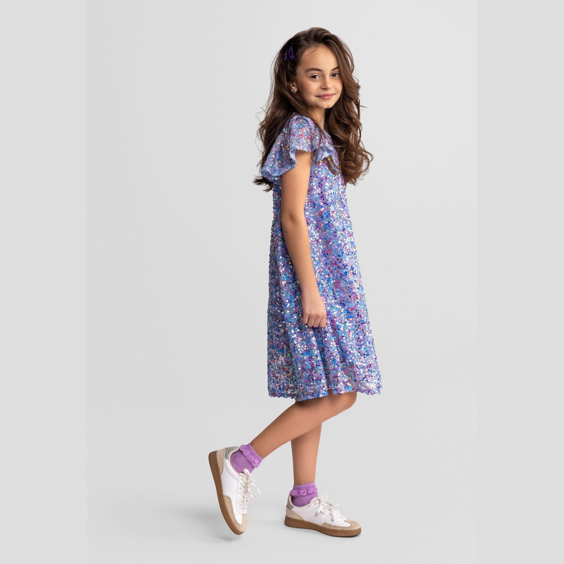 Back view of blue sequin dress showing full coverage sequin embellishment and button closure detail on white background