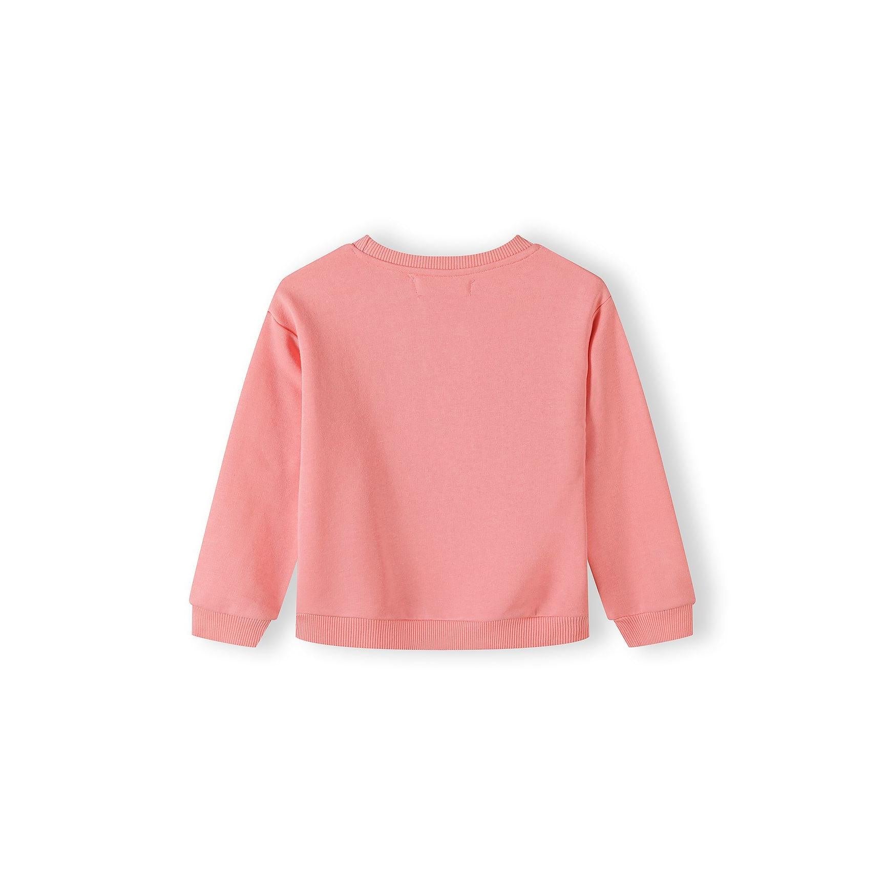 Close-up detail of coral pink sweatshirt showing Hello Flower text with smiling daisy graphics and Minoti label at neckline