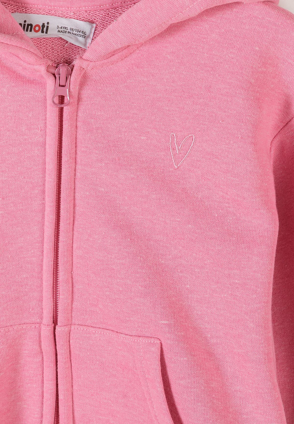 Close-up of the pink hoodie's zipper and small pale embroidered outline heart.