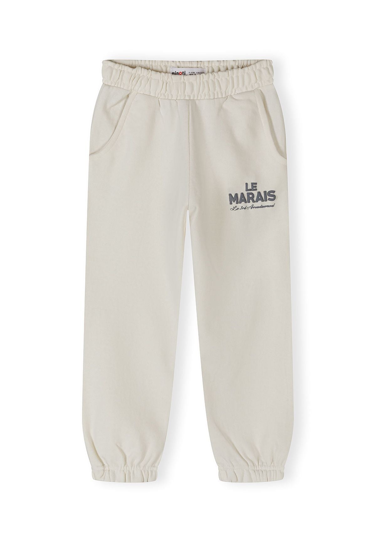 Detail of off-white joggers with elasticated cuffs and side pockets.
