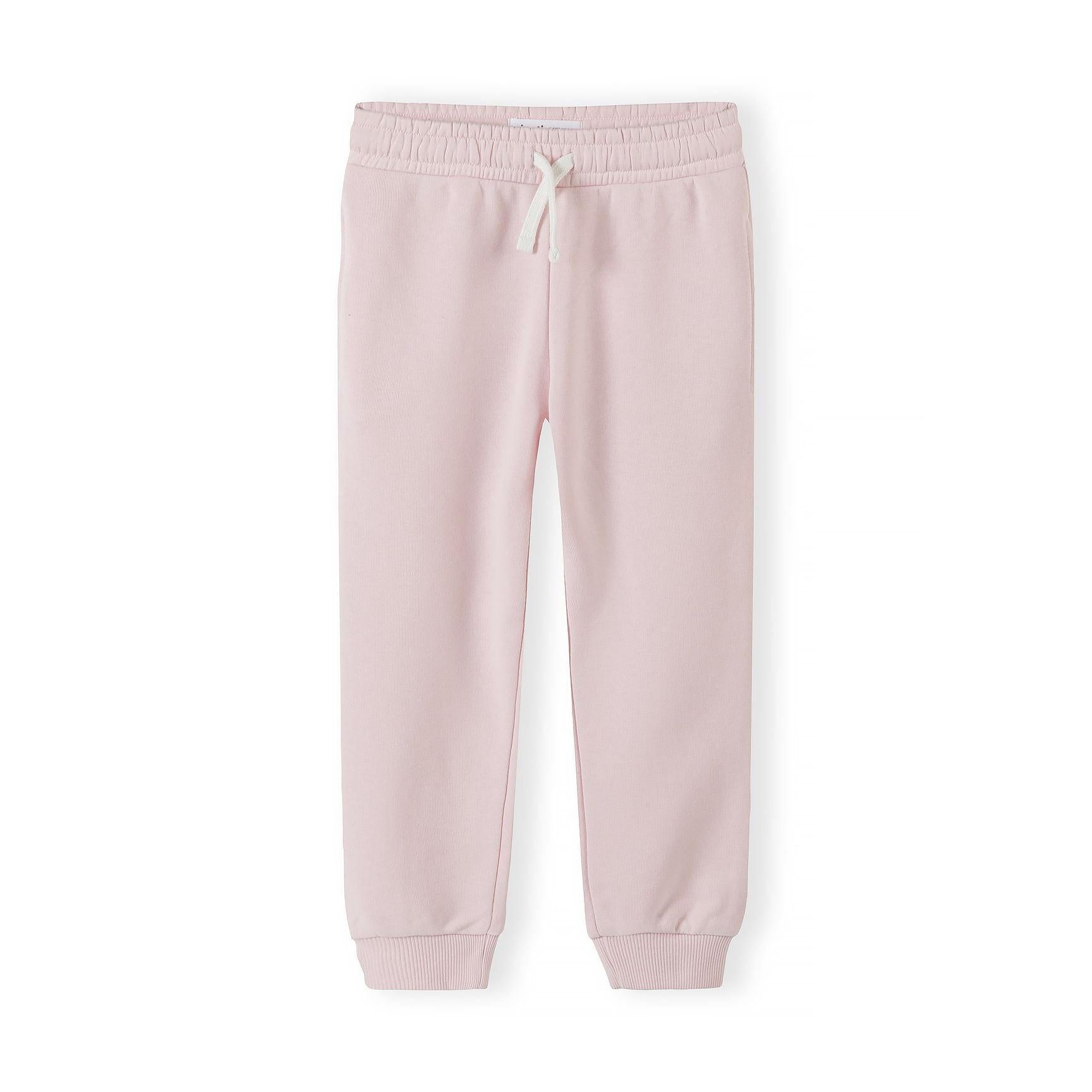 Single light pink joggers laid flat showing full length with white drawstring, elastic waistband and ribbed cuffs on white background