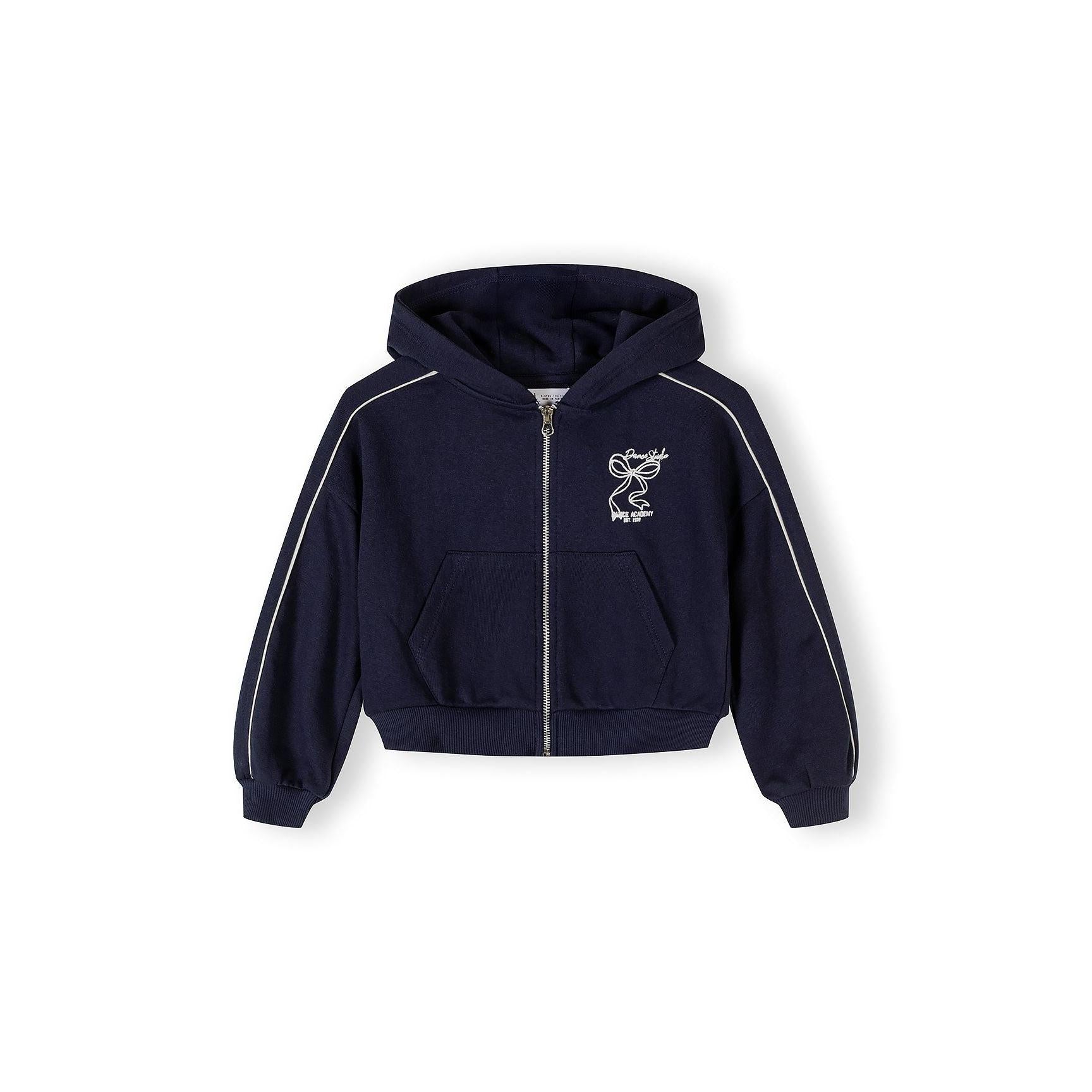 Close-up detail of navy tracksuit jacket showing Dance Studio logo embroidery, silver zip and front kangaroo pocket
