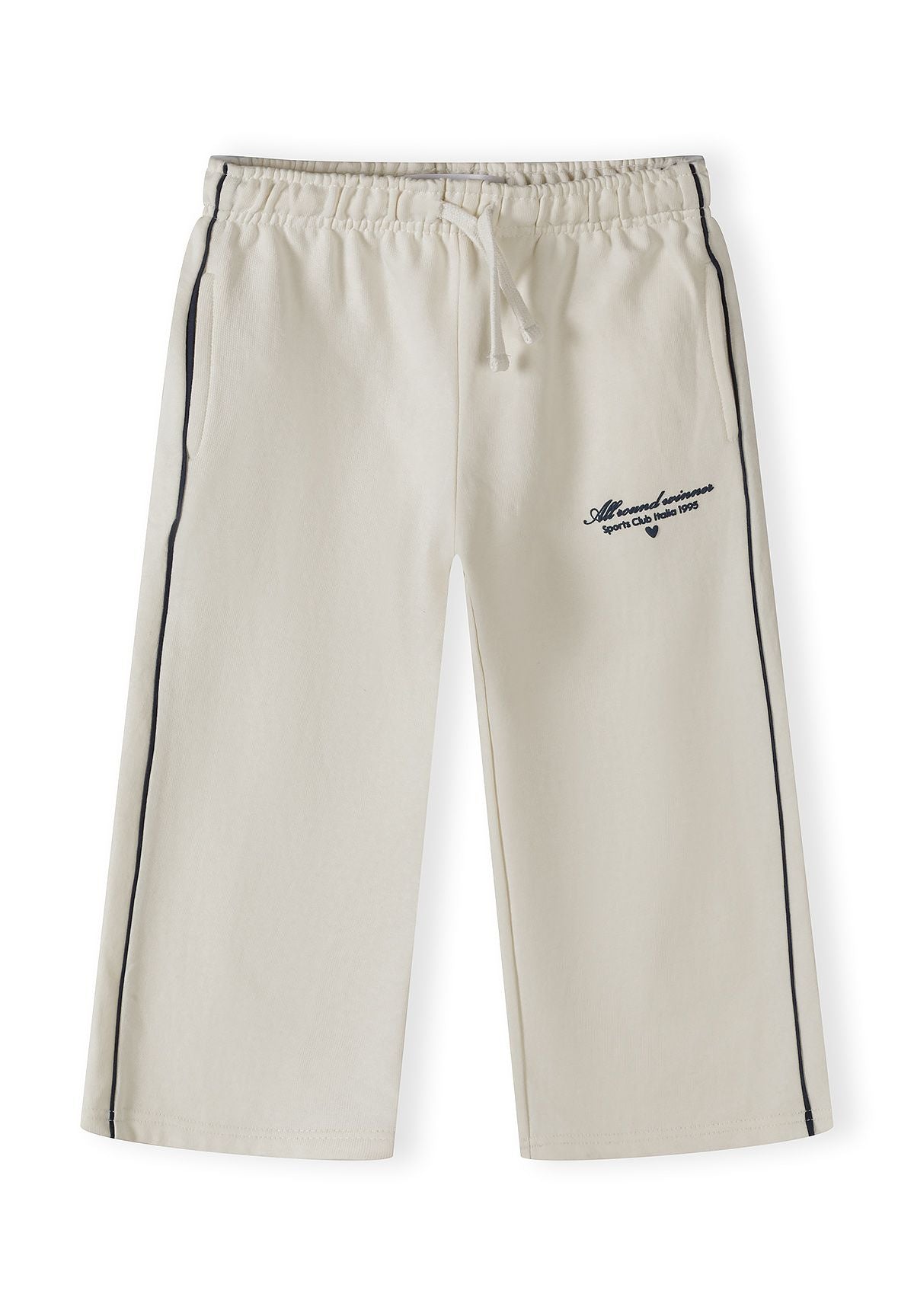 Detail of girls' beige jogging bottoms with elastic waistband and side pockets.