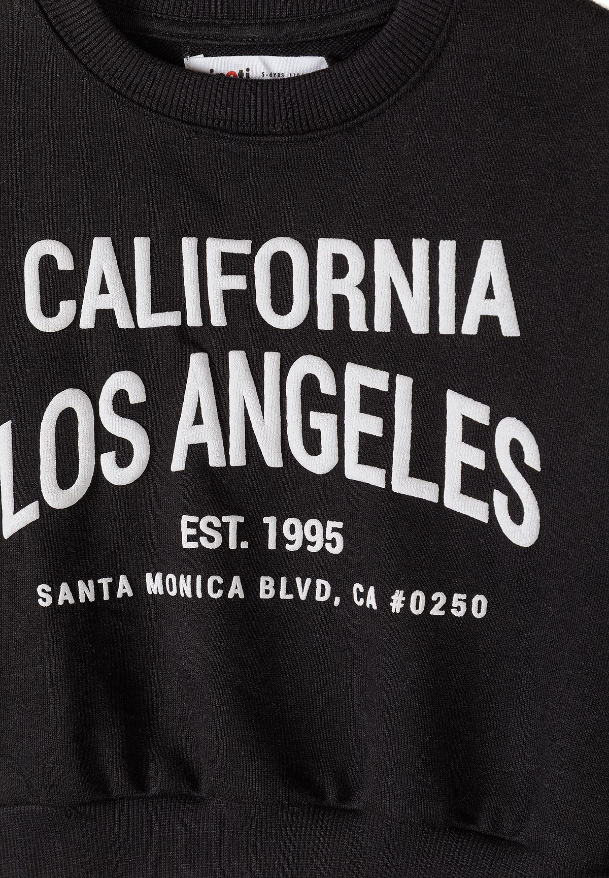 Detail of a black sweatshirt with white 'California Los Angeles' text.