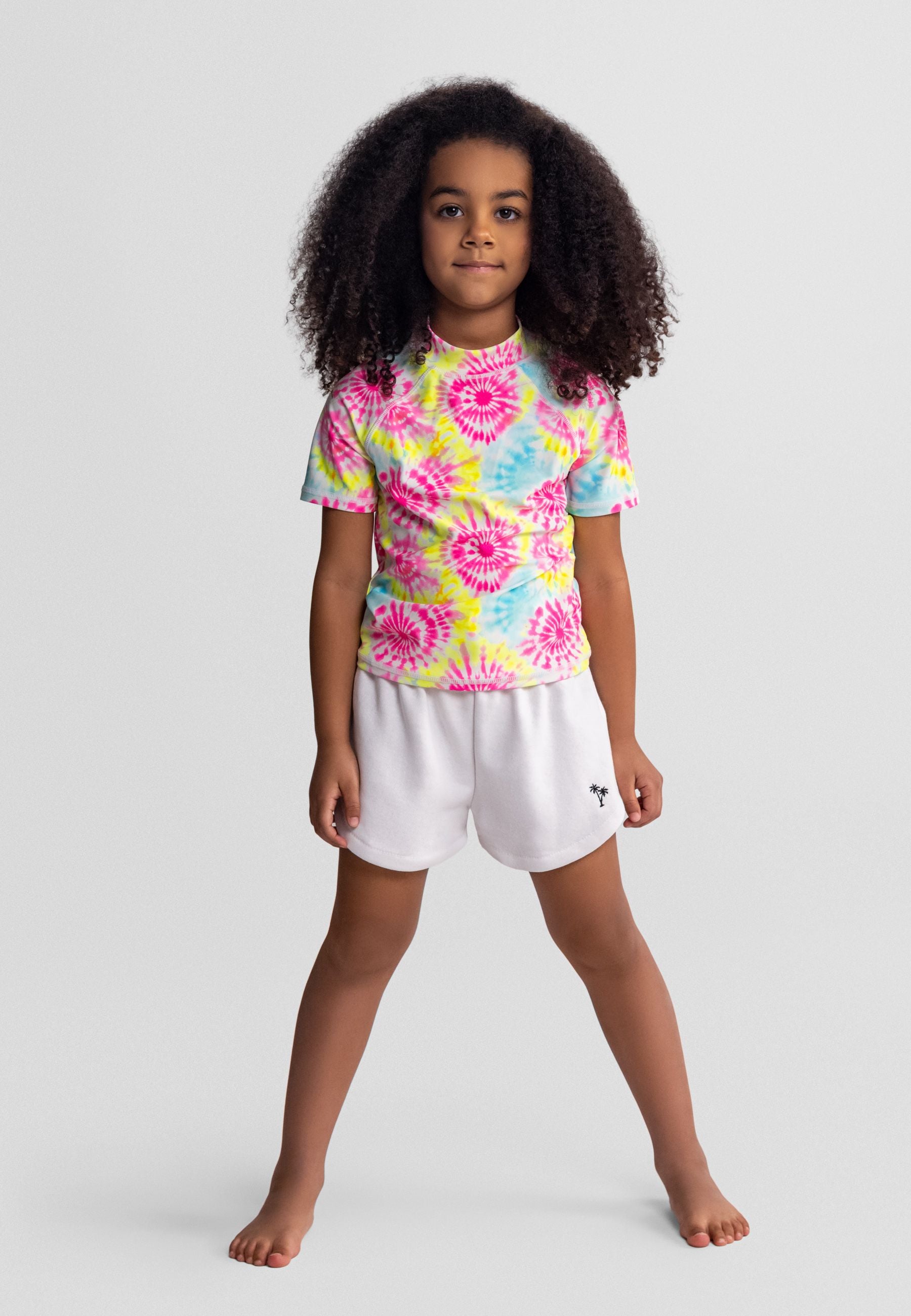 Girls' white shorts with pink embroidery, front view, elastic waistband and side pockets.