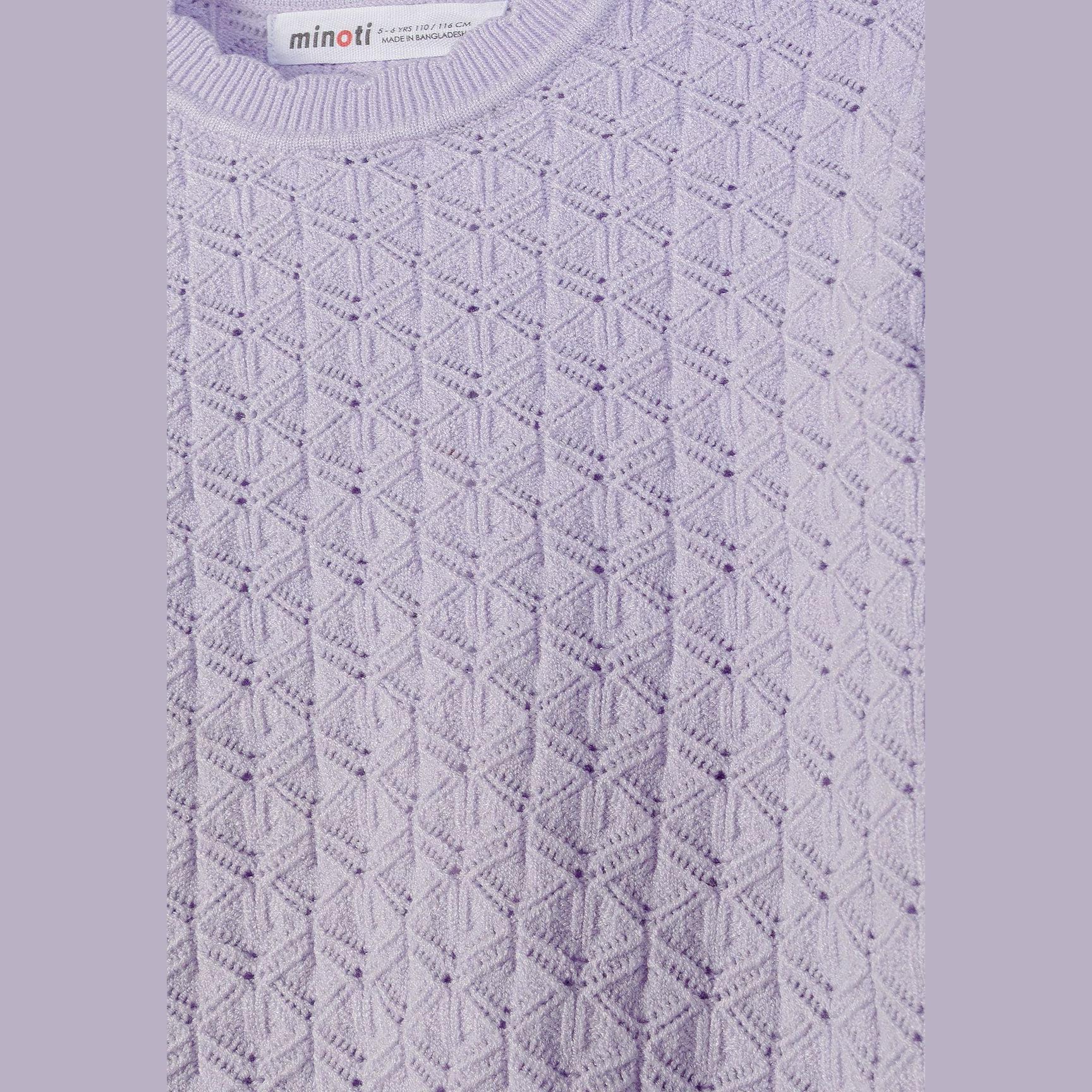 Close-up detail of lilac jumper showing intricate diamond pointelle knit pattern with Minoti label visible at neckline