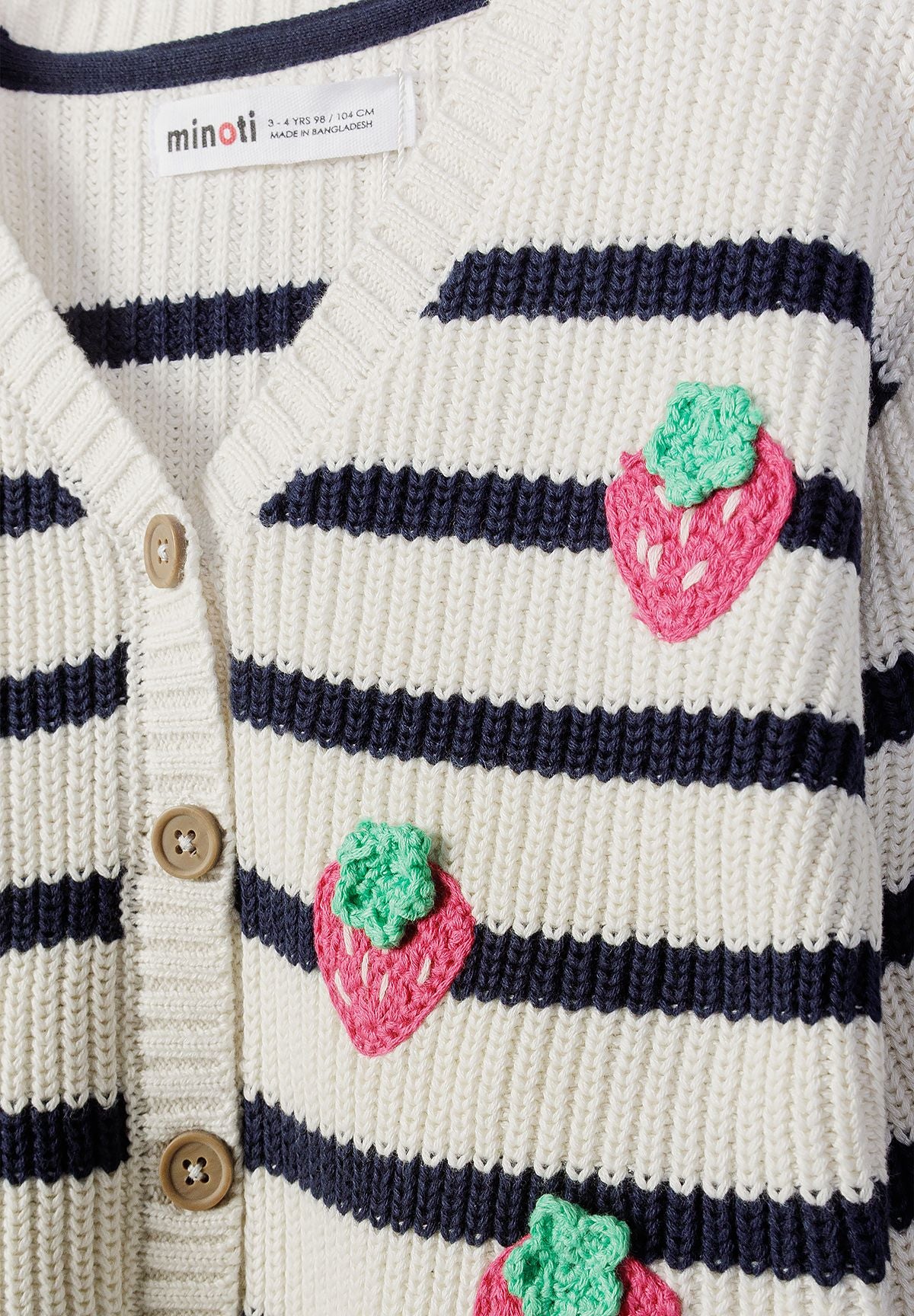 Close-up of navy striped cardigan with textured pink and green strawberries.