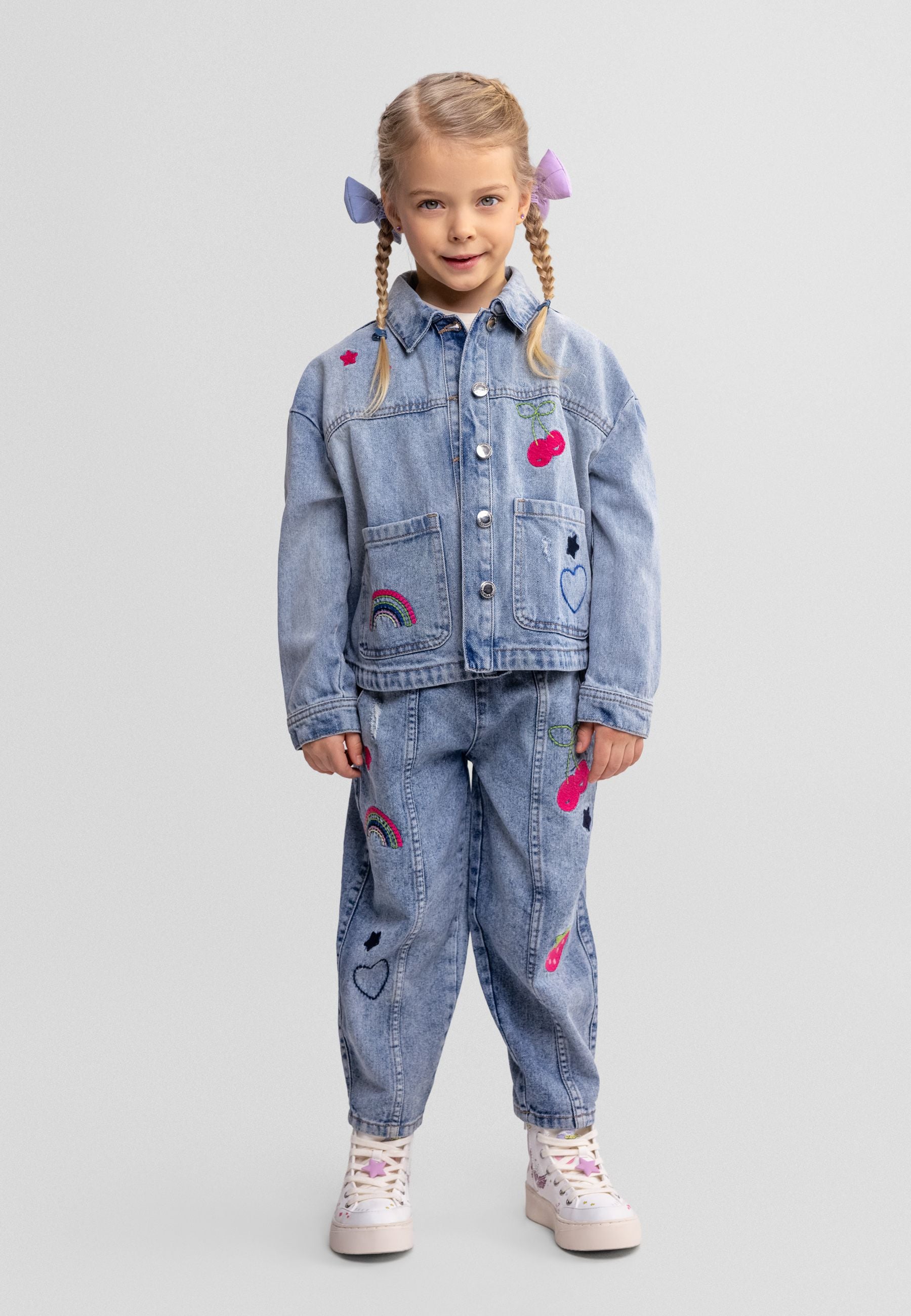 Girls' blue denim barrel shape jeans with embroidered details, front view.