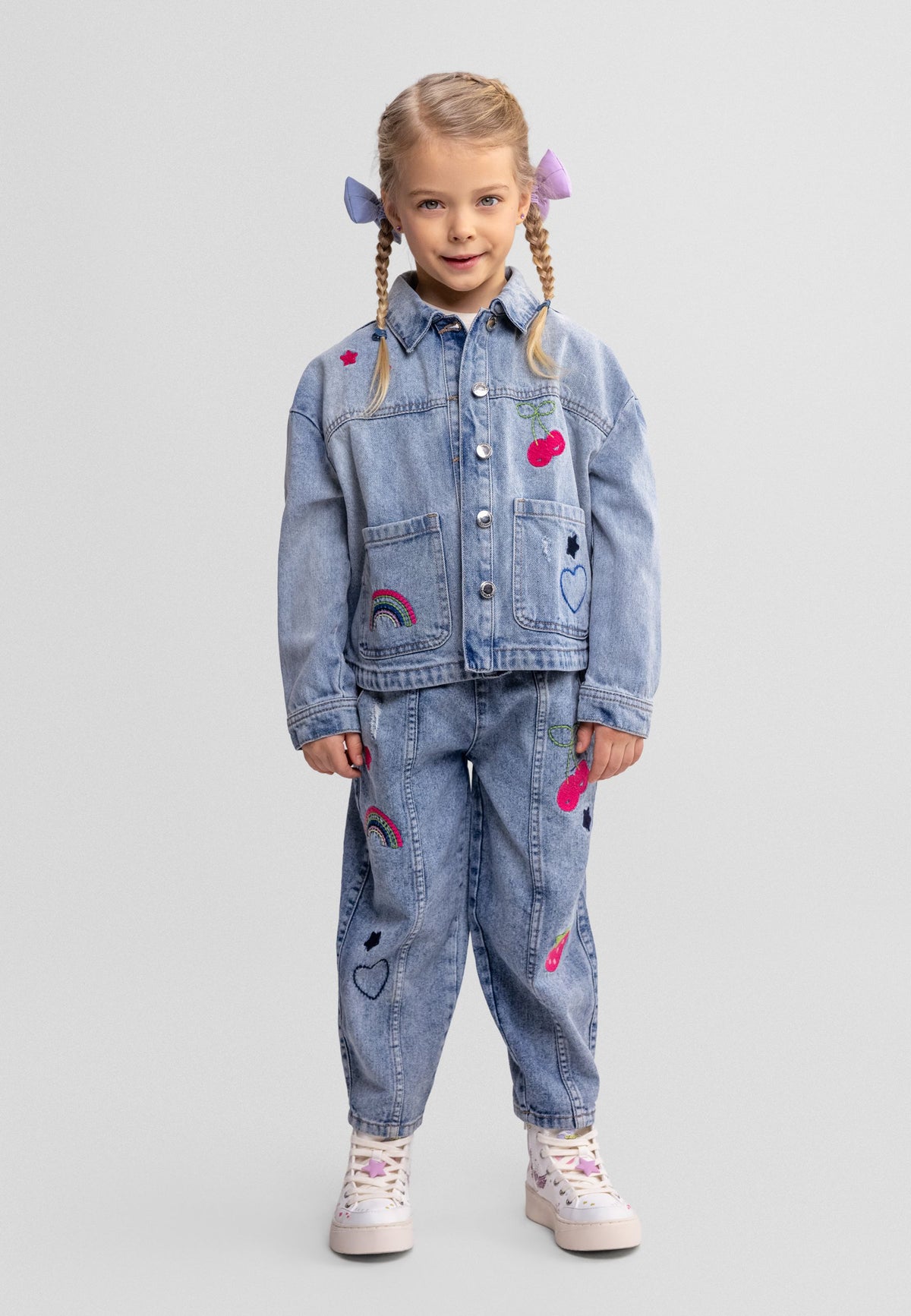 Light blue embroidered pull-on jeans, model front.