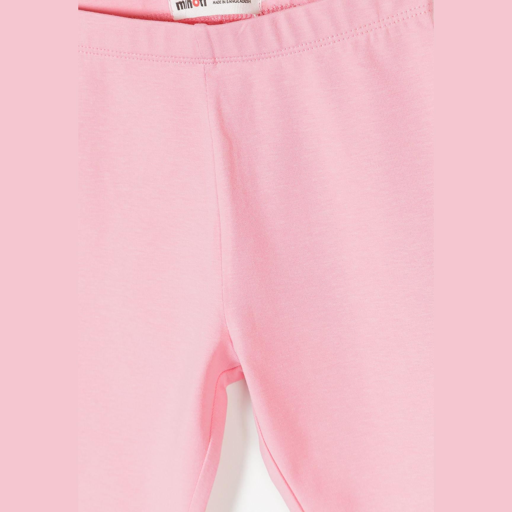 Close-up detail of pink capri leggings showing fabric texture, seam construction and Minoti label at waistband