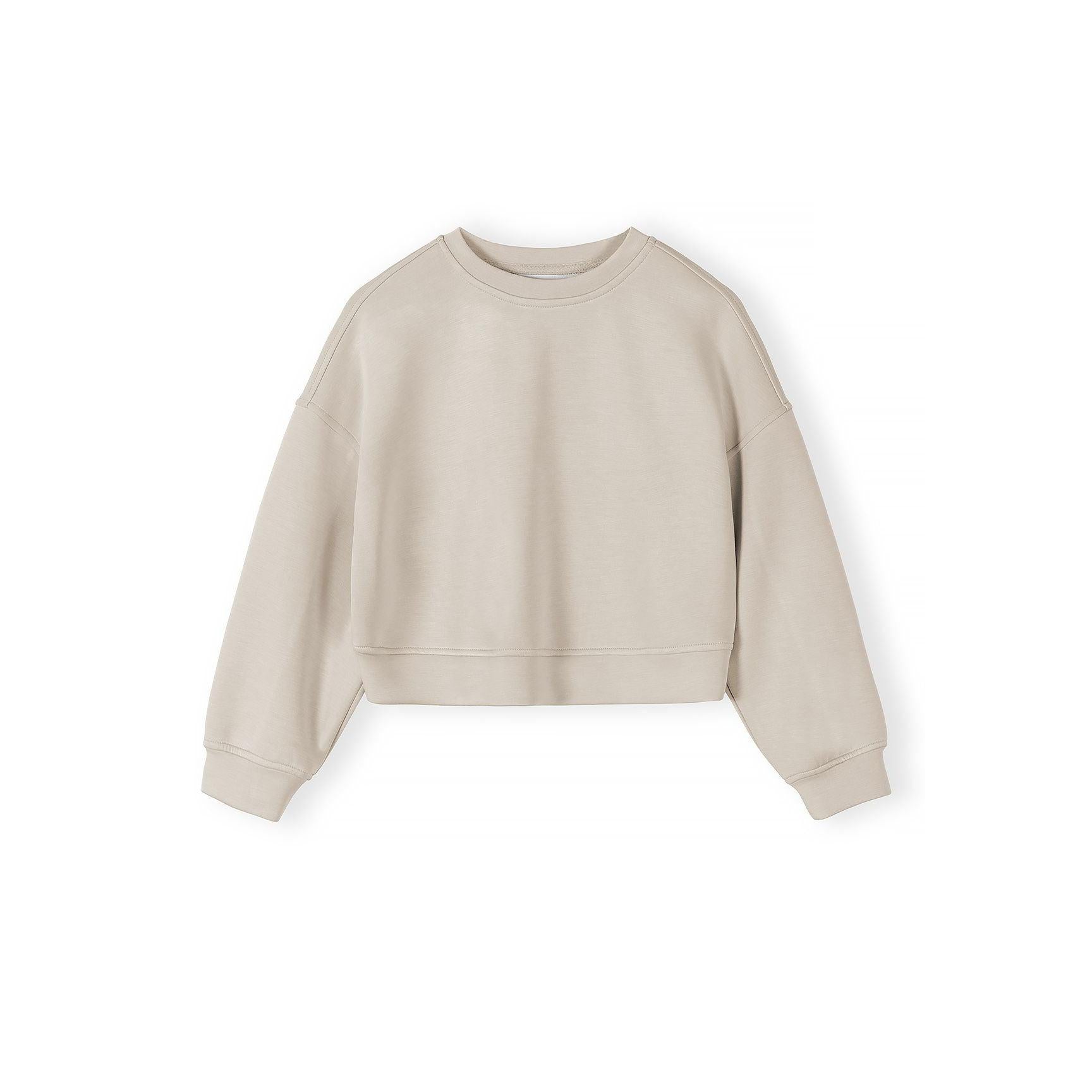 Beige sweatshirt laid flat showing relaxed crew neck design and long sleeves on white background