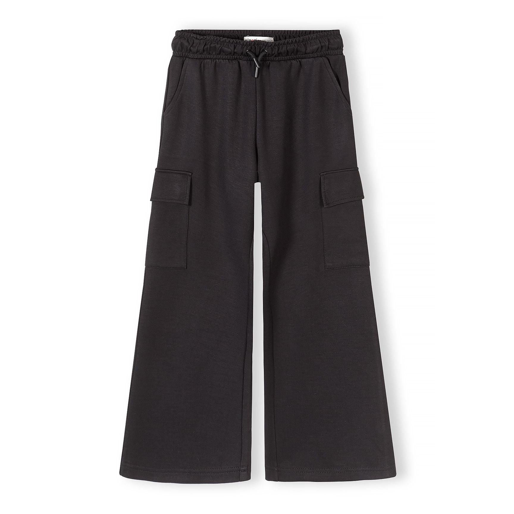 Flat lay of black wide leg joggers showing full silhouette with cargo pockets on sides and elasticated waistband with drawstring
