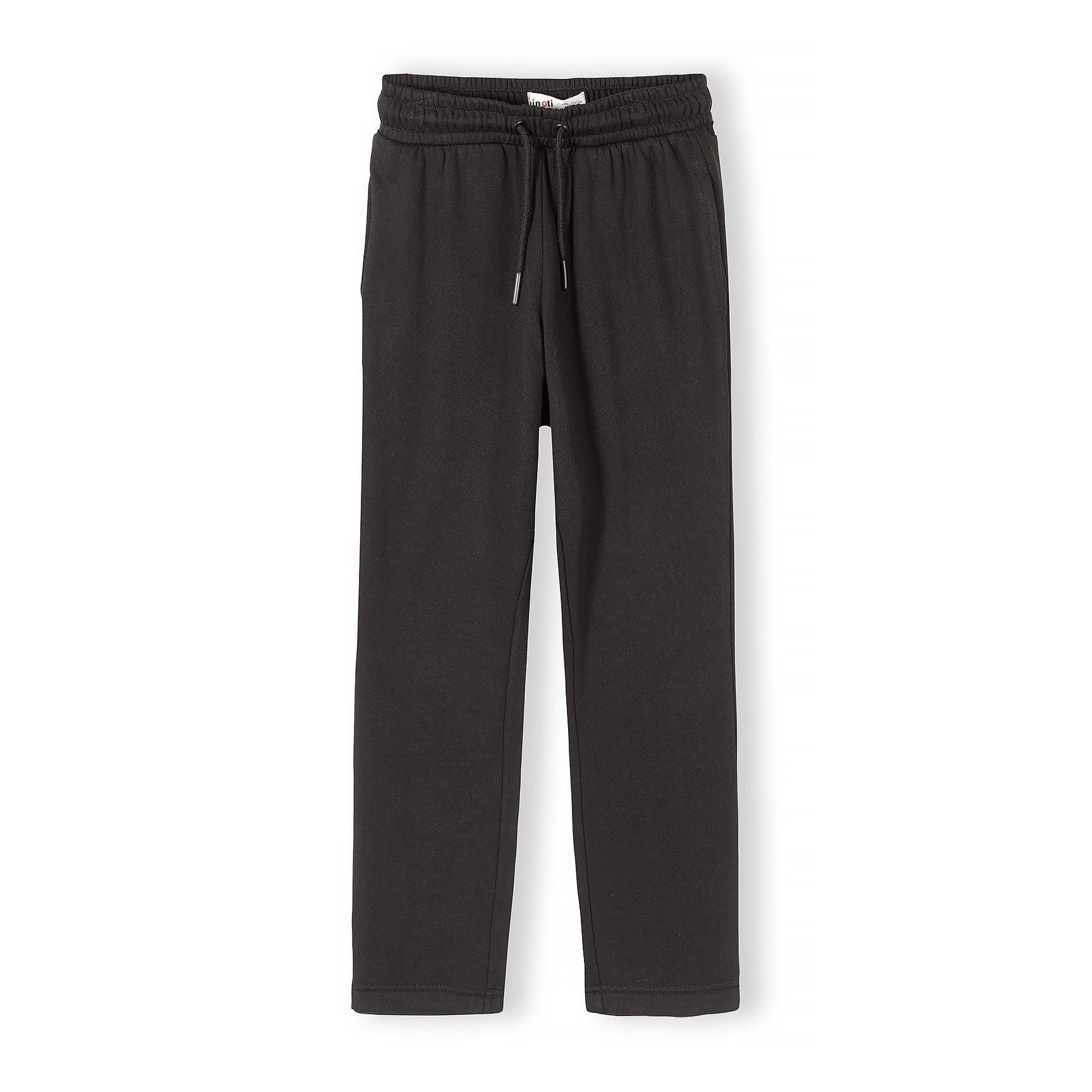 Black wide leg joggers with elastic waistband and drawstring on white background, front view showing full length relaxed fit
