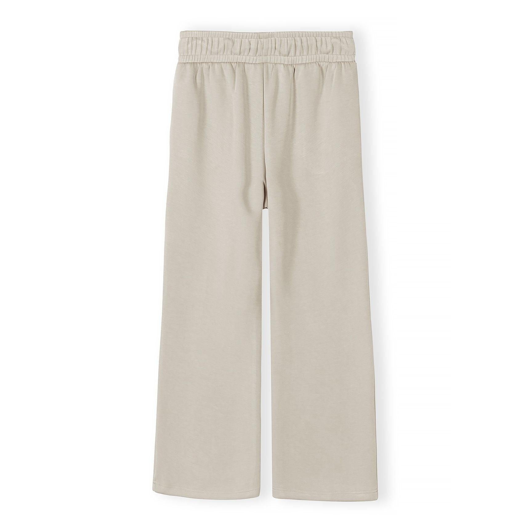 Beige wide leg joggers back view flat lay on white background showing elastic waistband and straight wide leg silhouette