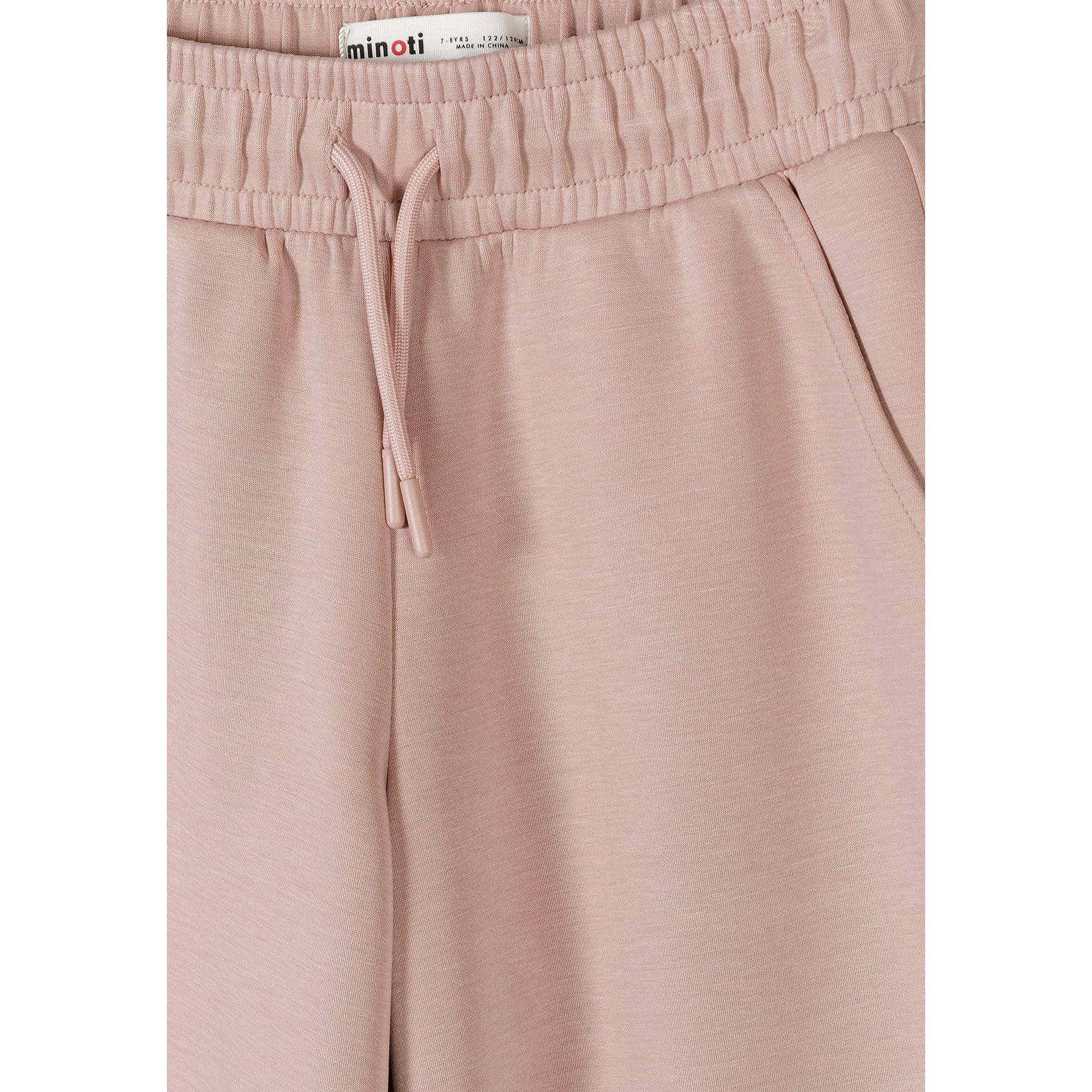Close-up detail of pink joggers showing Minoti label, elasticated waistband with drawstring ties and smooth viscose fabric texture