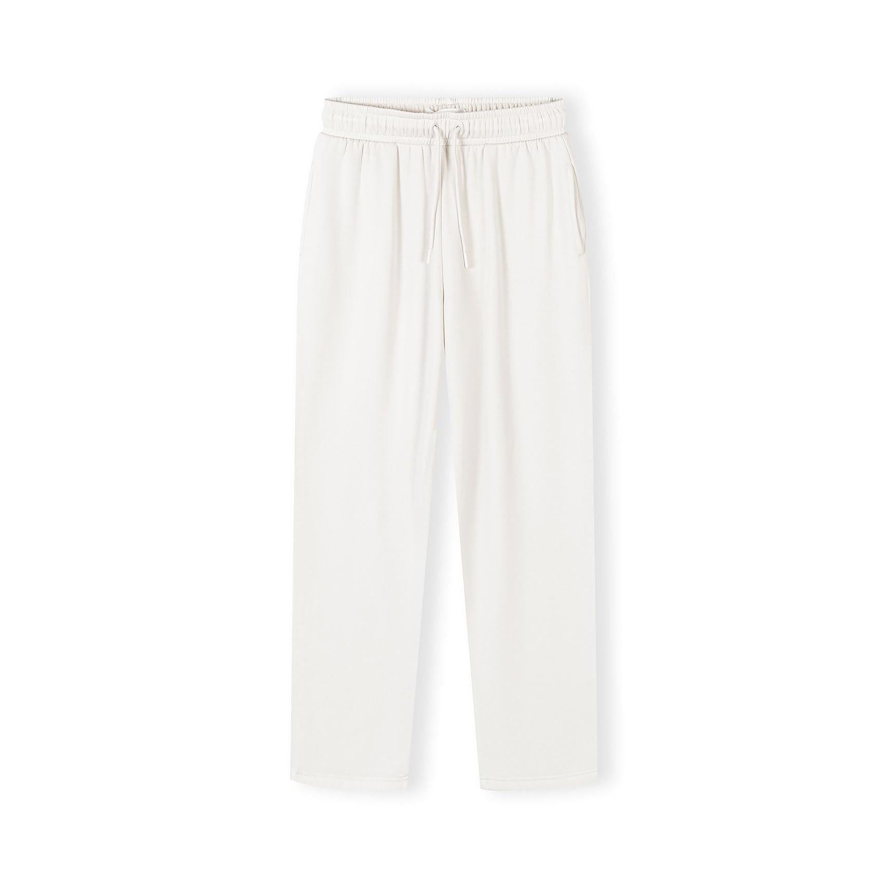 Wide leg joggers in off white viscose shown flat lay on light background, featuring elastic waistband with drawstring and relaxed flowing silhouette