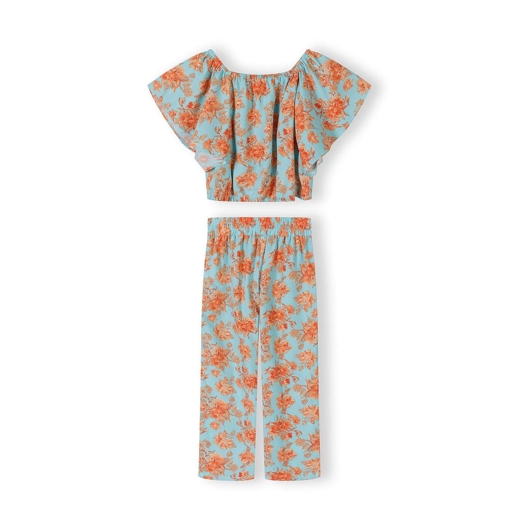 Close-up detail of light blue viscose trousers with orange floral print showing elasticated waistband and wide-leg cut