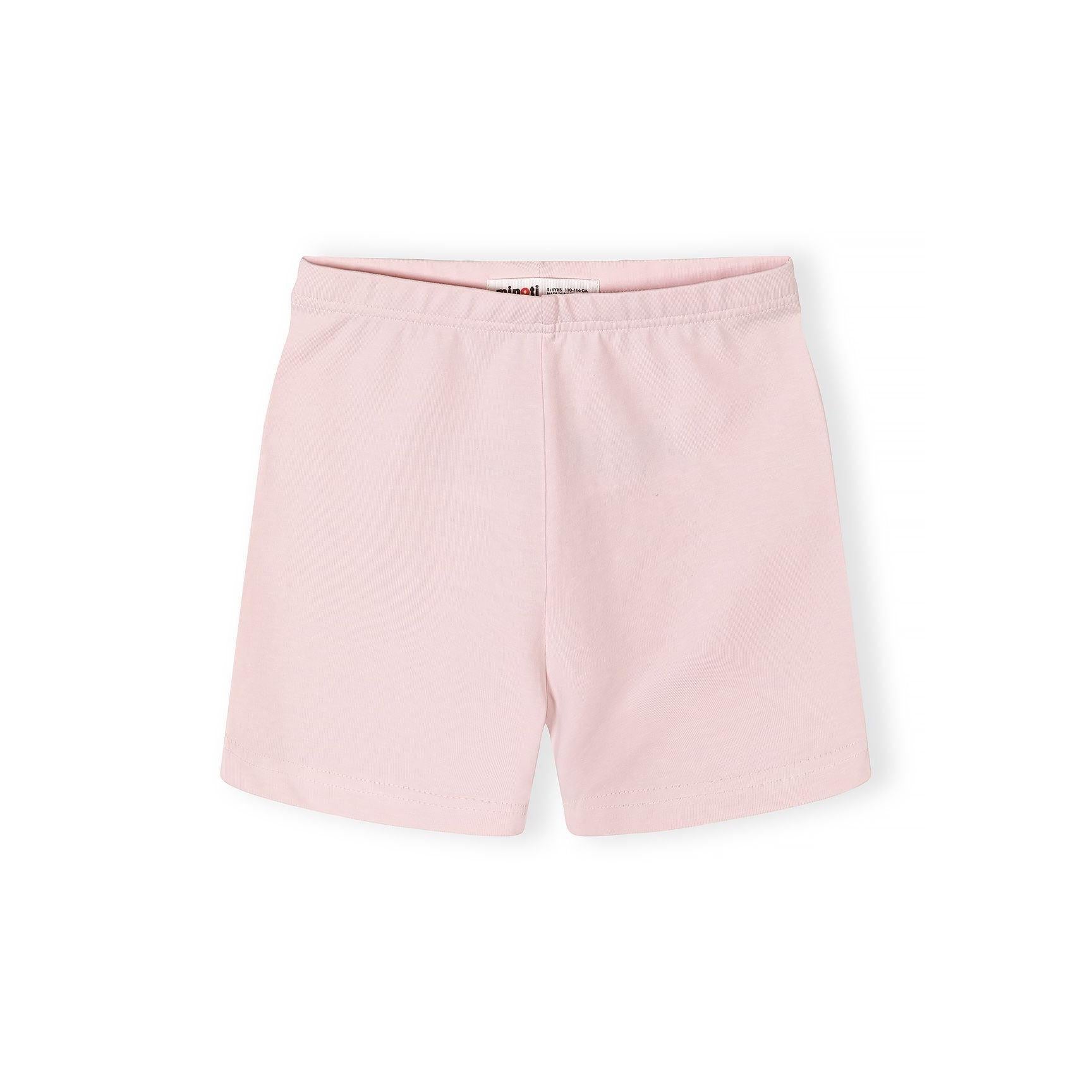 Close-up detail of pink t-shirt showing CAPRI text in yellow letters with 'la dolce vita' script and palm tree graphic with sun design