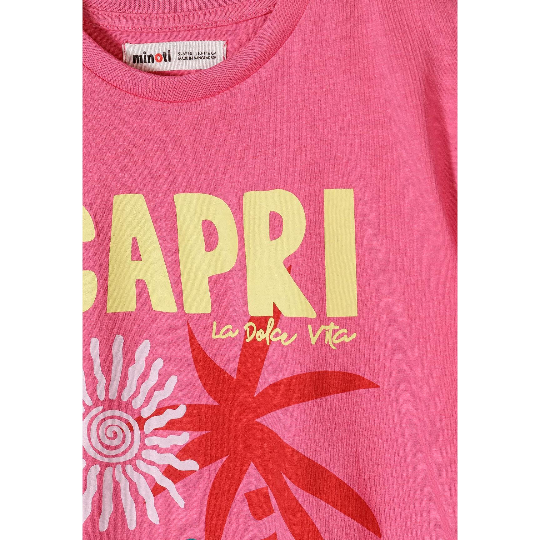 Close-up detail of pink t-shirt showing CAPRI text in yellow letters with 'la dolce vita' script and palm tree graphic with sun design