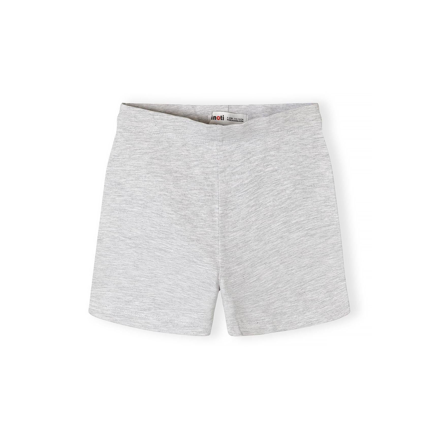 Close-up detail of blue cycling shorts showing fabric texture, stitching quality and Minoti label with brand name clearly visible