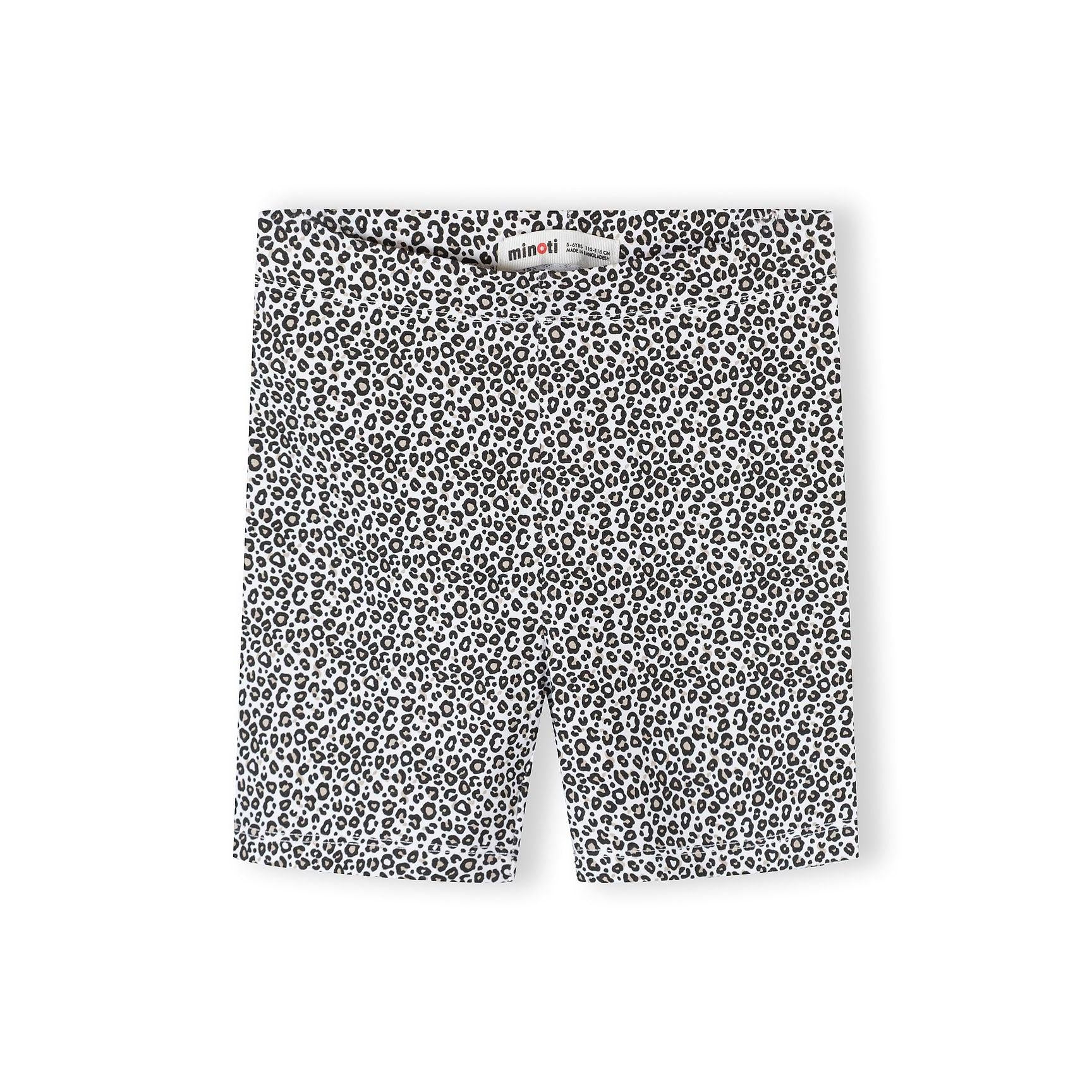 Single pair of cycling shorts in white and black leopard print pattern laid flat against white background, showing Minoti brand label
