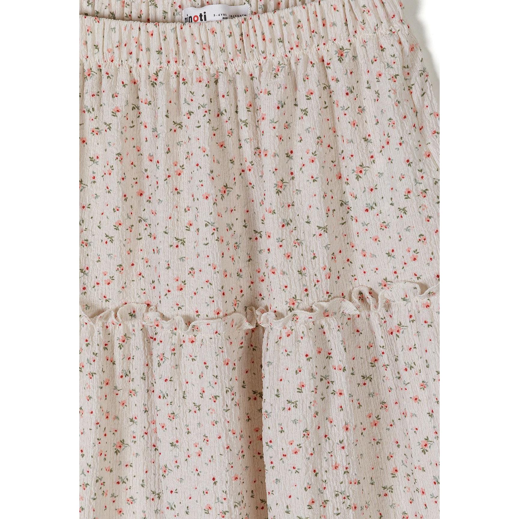 Close-up detail of cream floral fabric showing delicate coral and green flower print pattern with Minoti label