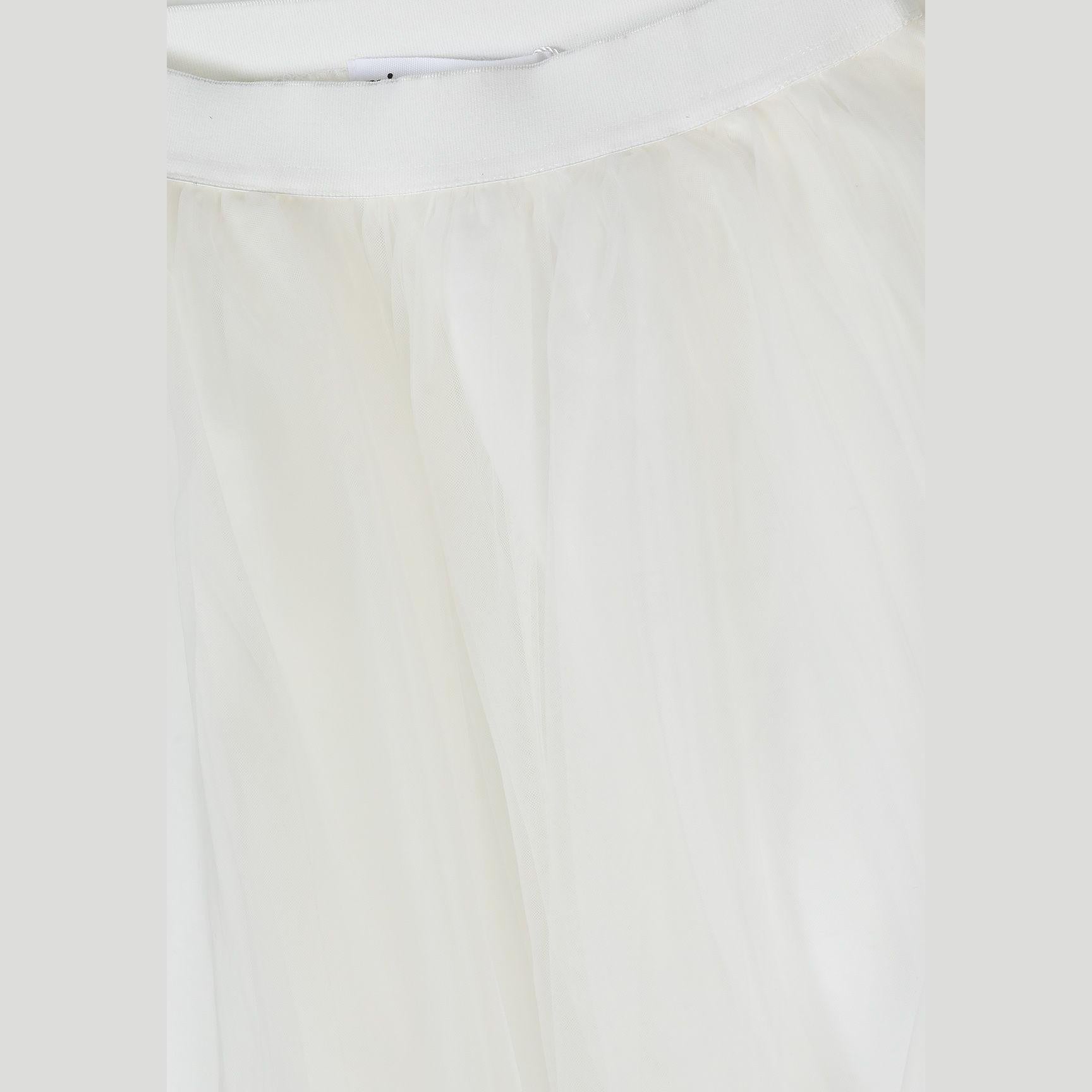 Close-up detail of off white pleated tulle fabric showing fine texture and elastic waistband construction