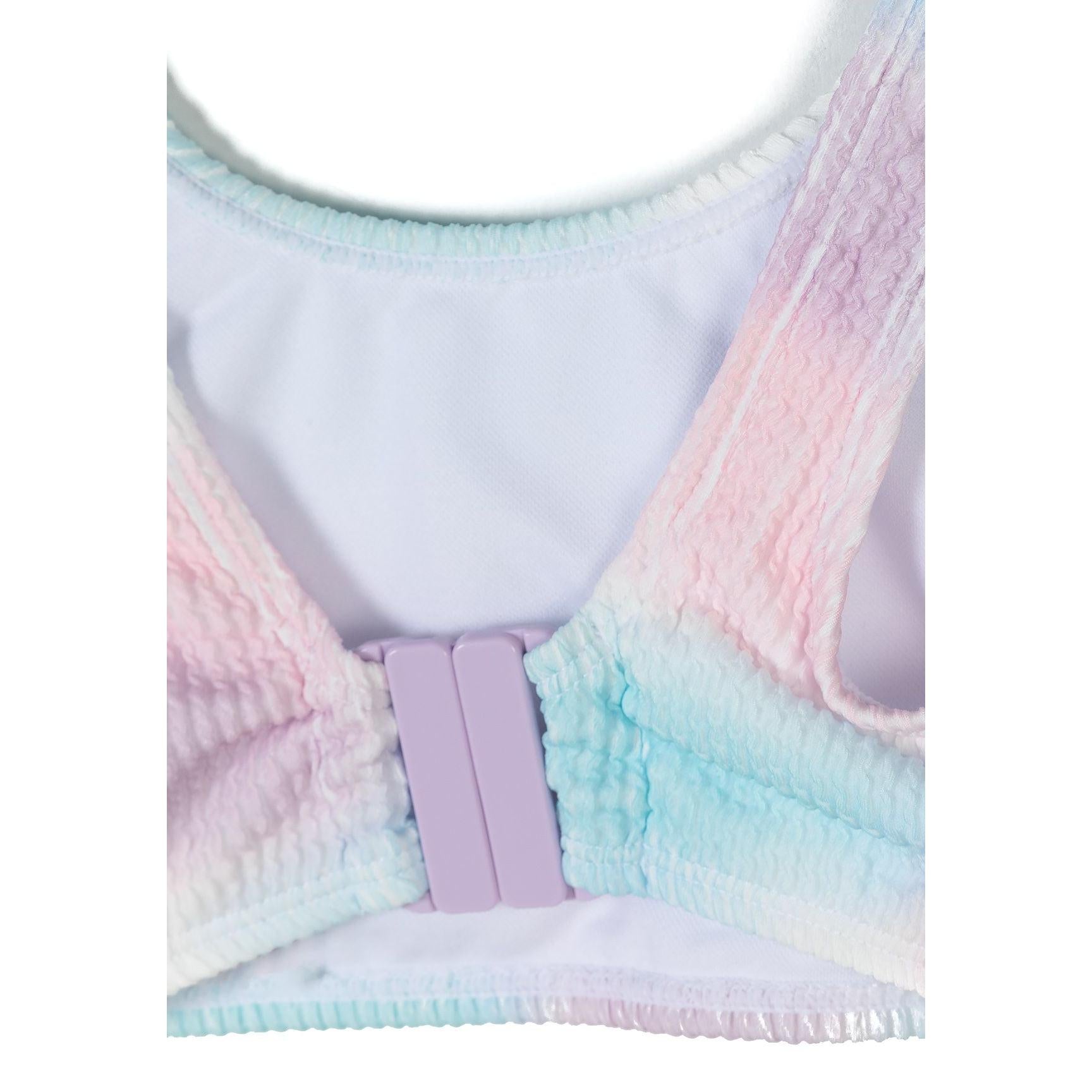 Detail view of bikini top showing adjustable pink buckle closure and ribbed fabric texture in tie-dye pattern against white background