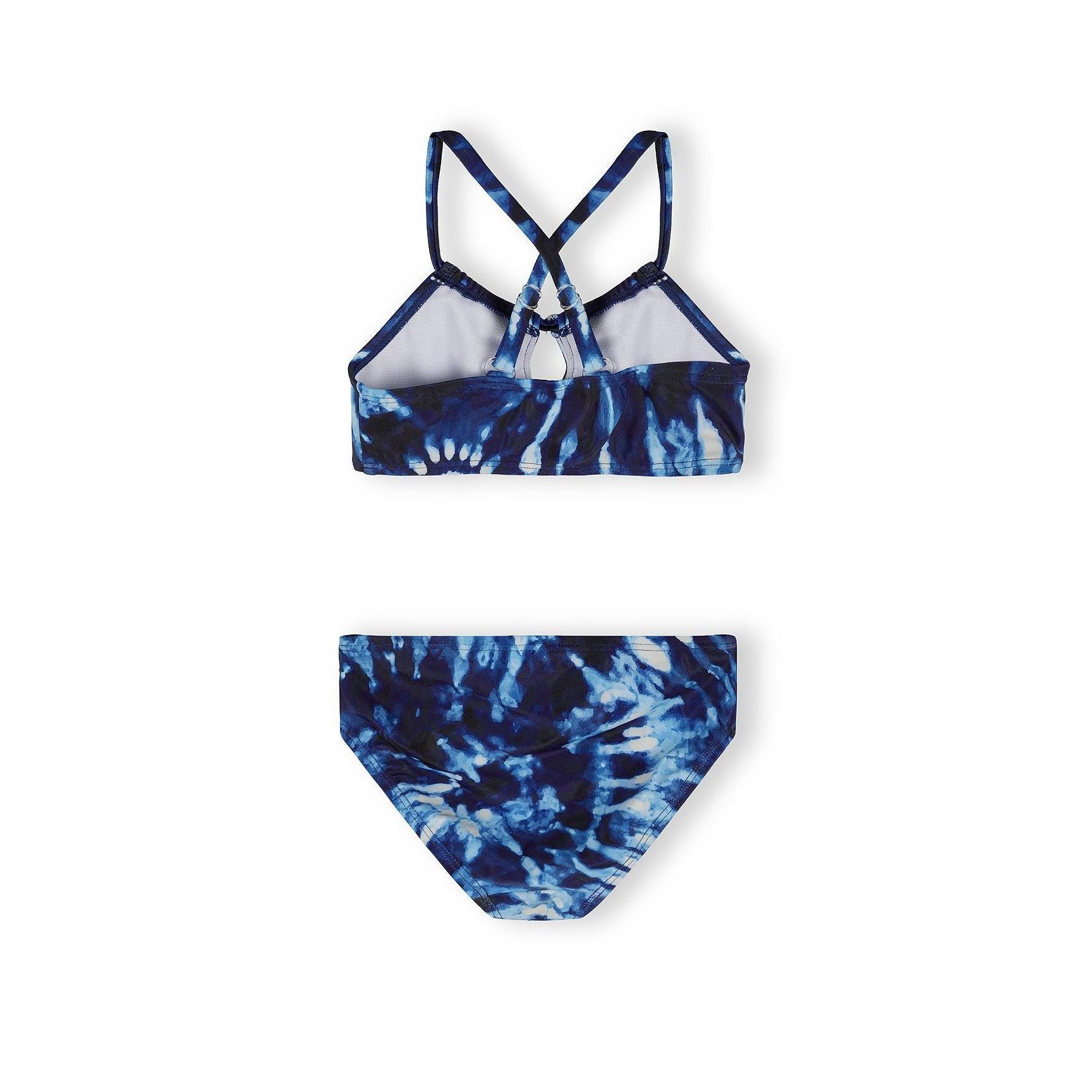 Detail view of blue tie-dye bikini top showing cross-back strappy design and tie-dye pattern in navy and light blue