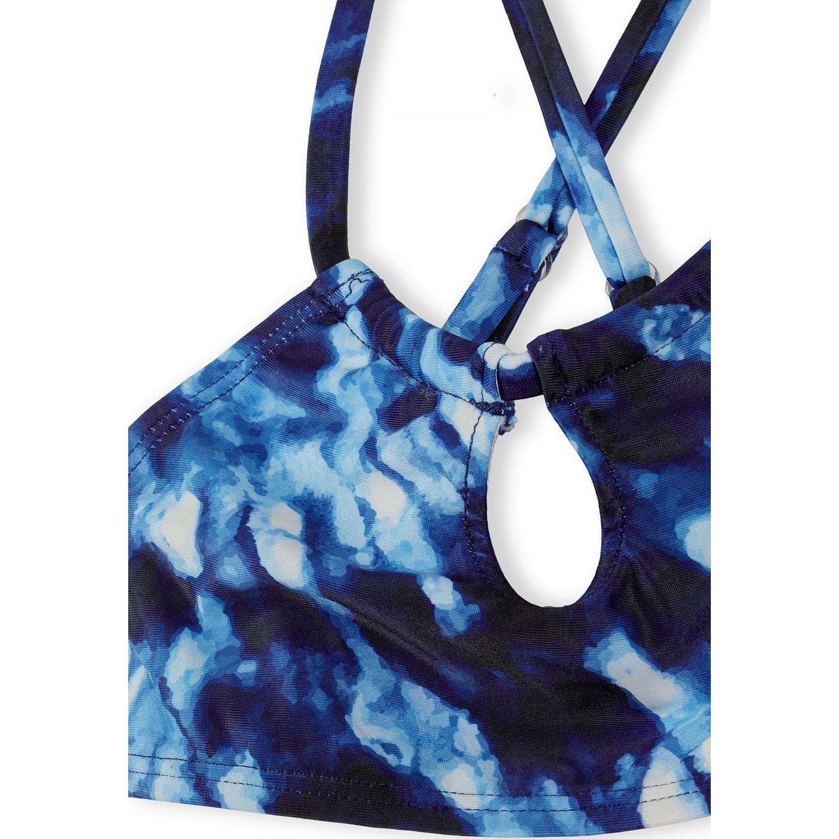 Detail view of blue tie-dye bikini top showing cross-back strappy design and tie-dye pattern in navy and light blue