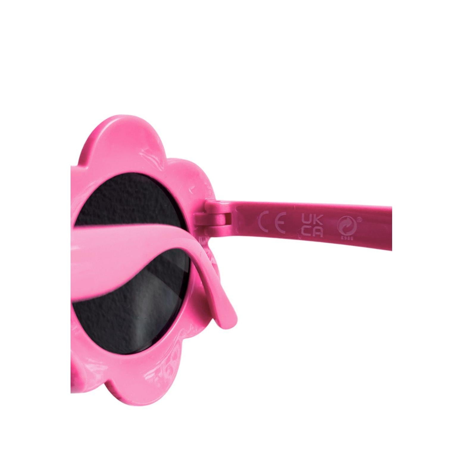 Close-up detail of pink floral-shaped children's sunglasses showing CE safety marking and comfortable design