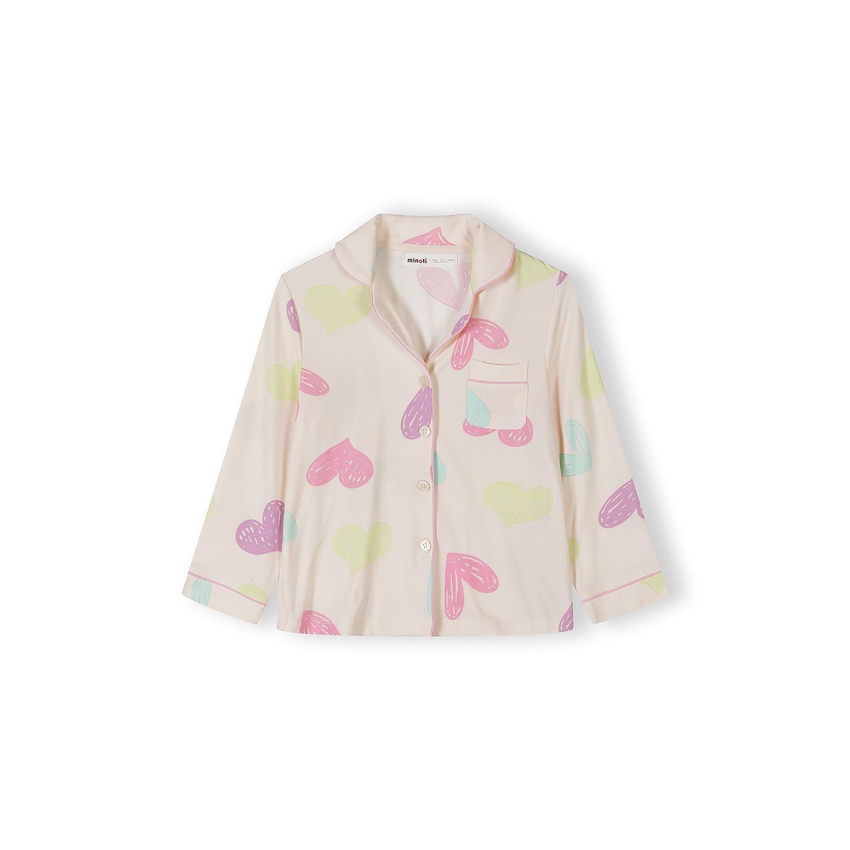 Close-up of pink pyjama top with heart print showing long sleeves, button front closure and chest pocket detail