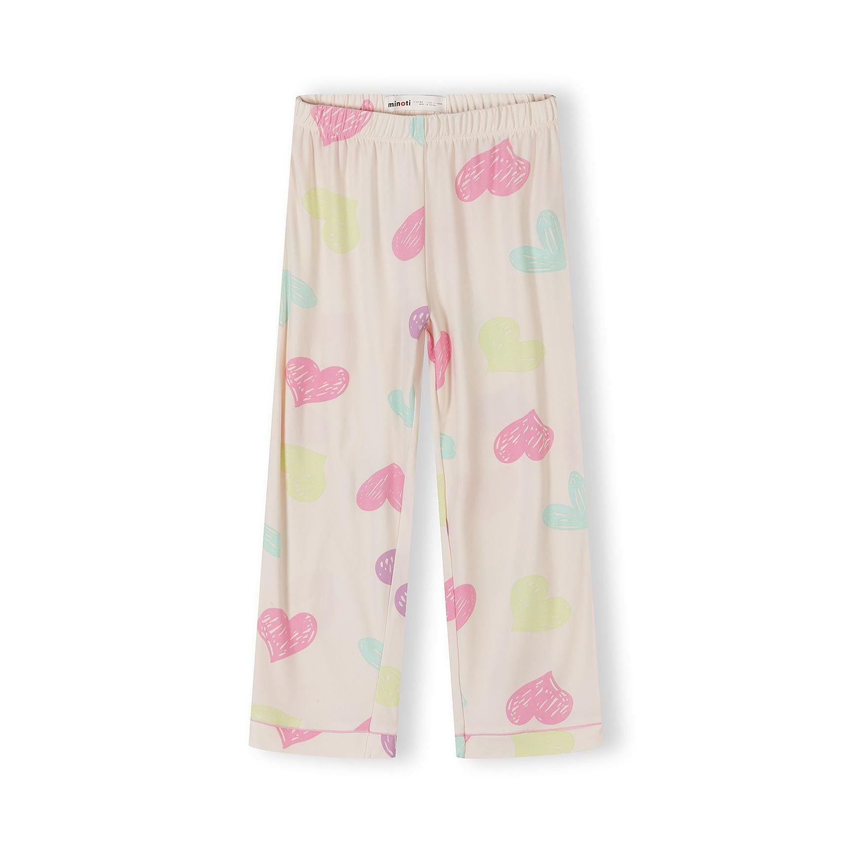 Detail shot of pyjama top showing Minoti label, button closure, heart pattern and chest pocket with pink trim